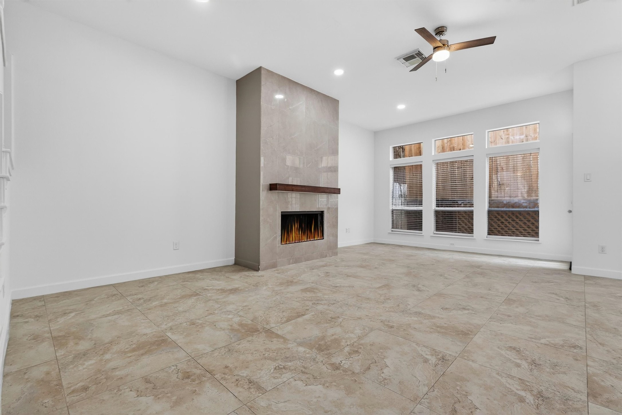 Designer porcelain fireplace feature wall adds warmth and sophistication to the living area. Designer porcelain fireplace feature wall adds warmth and sophistication to the living area.
