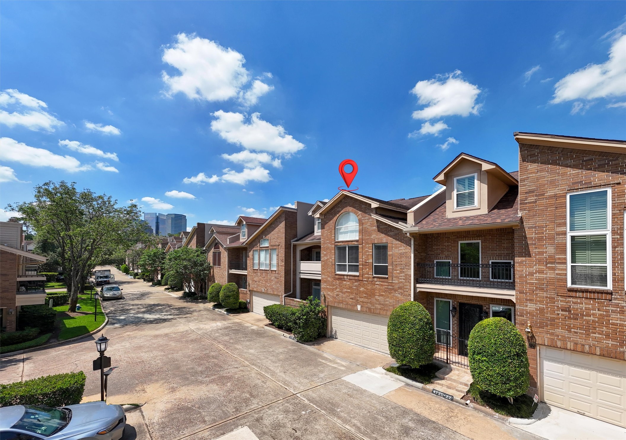 Beautiful brick townhome with private driveway and attached garage located in a desirable gated-style community near shopping, dining, and major commuter routes. Features attractive curb appeal, mature landscaping, private balcony, and low-maintenance living with easy access to city amenities and entertainment.