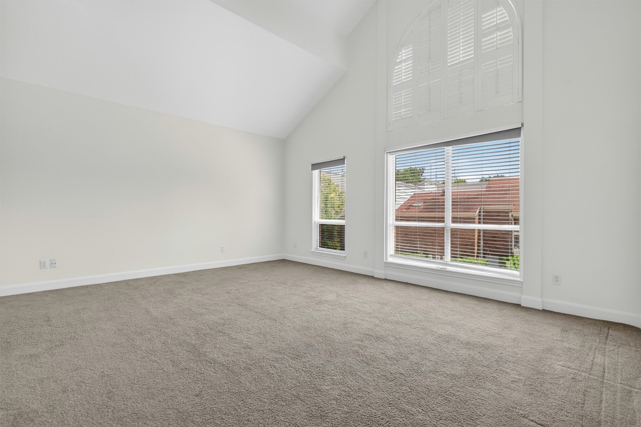 Oversized primary suite with vaulted ceilings and relaxing retreat-style atmosphere.