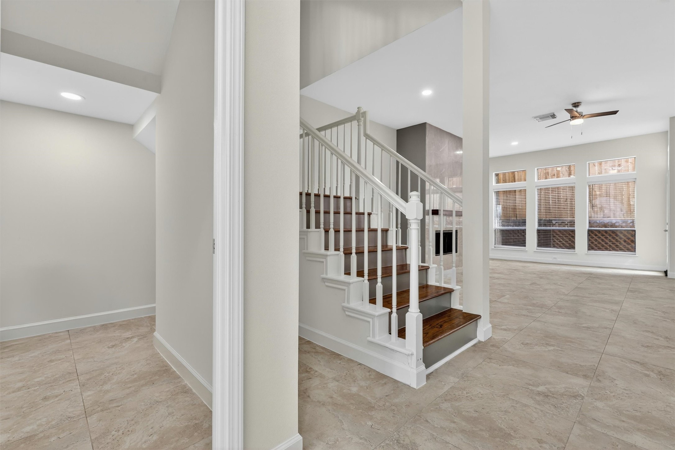 Elegant entryway with upgraded staircase, wood stair treads, soaring ceilings, and open-concept design leading into the spacious living area. Abundant natural light, tile flooring throughout main areas, recessed lighting, and modern finishes create a bright and inviting atmosphere perfect for entertaining and everyday living. Elegant entryway with upgraded staircase, wood stair treads, soaring ceilings, and open-concept design leading into the spacious living area. Abundant natural light, tile flooring throughout main areas, recessed lighting, and modern finishes create a bright and inviting atmosphere perfect for entertaining and everyday living.