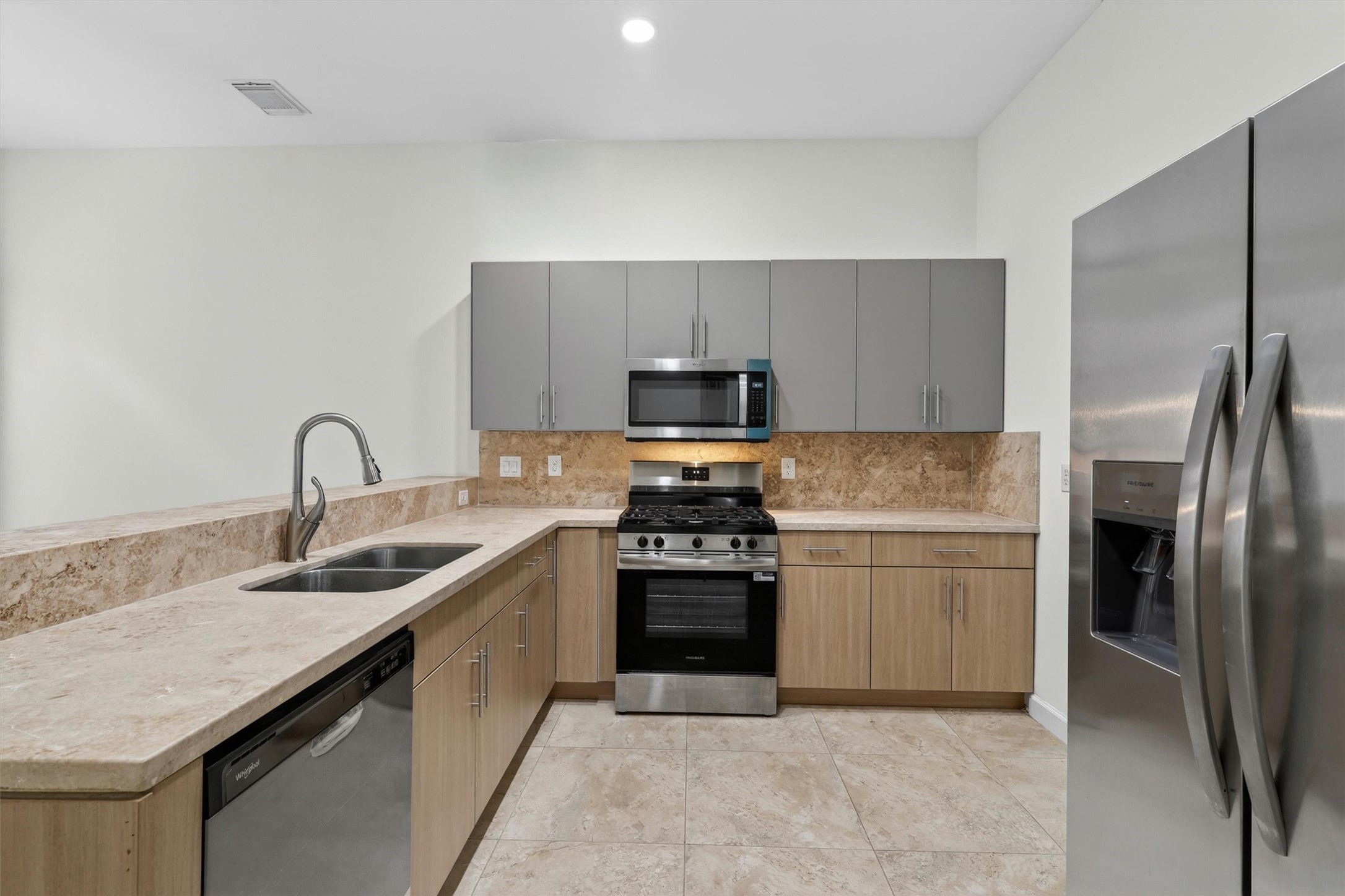 Beautifully upgraded kitchen with European frameless cabinetry and imported Cappuccino marble countertops.