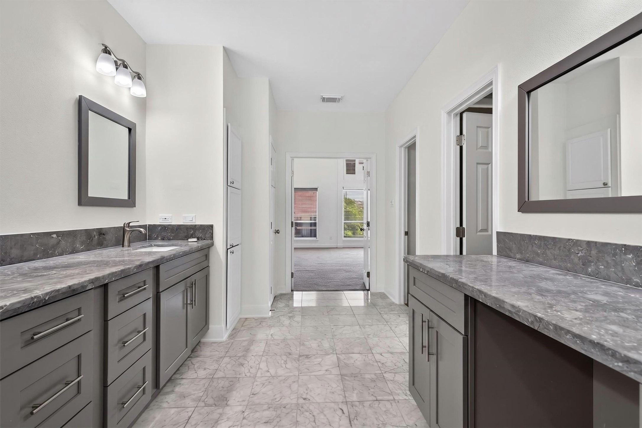 Spa-inspired primary bath featuring luxury finishes and custom dual vanities.