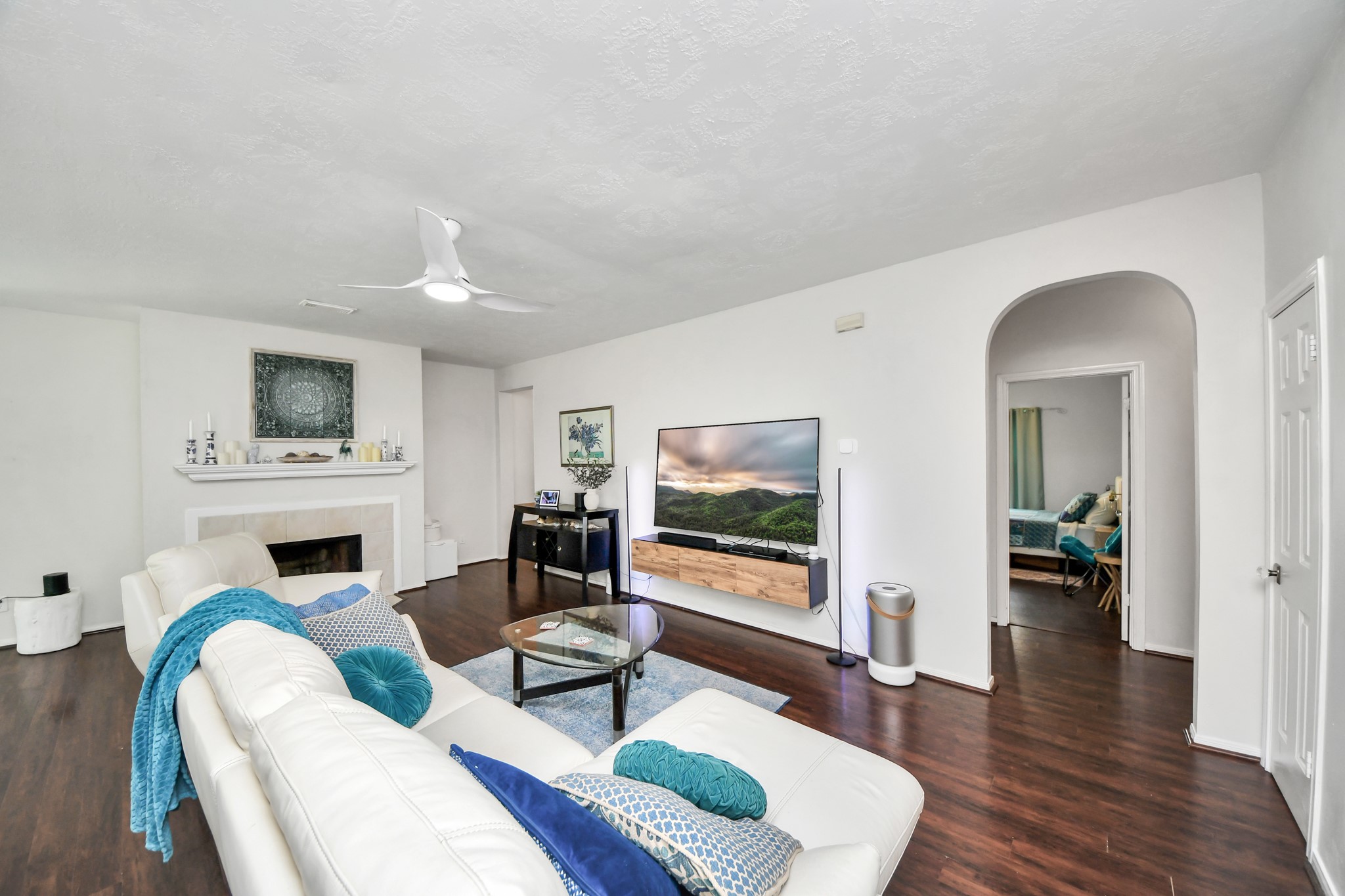 The family room includes a fireplace, a large entertainment wall, and flexible seating space.