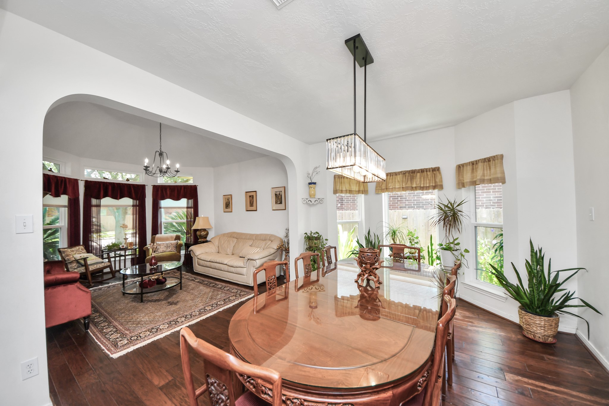 Large windows bring plenty of natural light into the connected formal living and dining spaces.