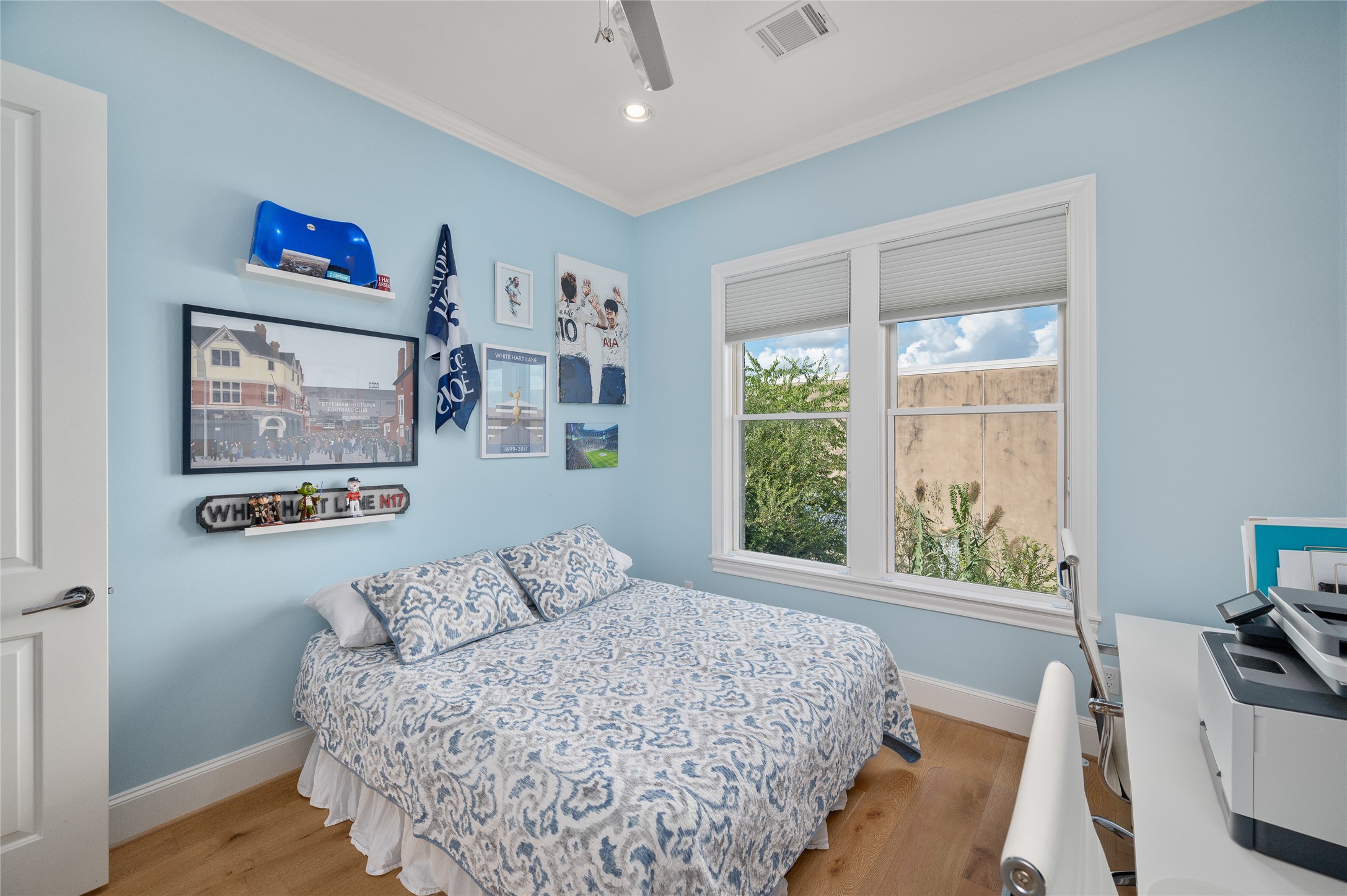 Secondary bedroom with two large windows and ceiling fan.