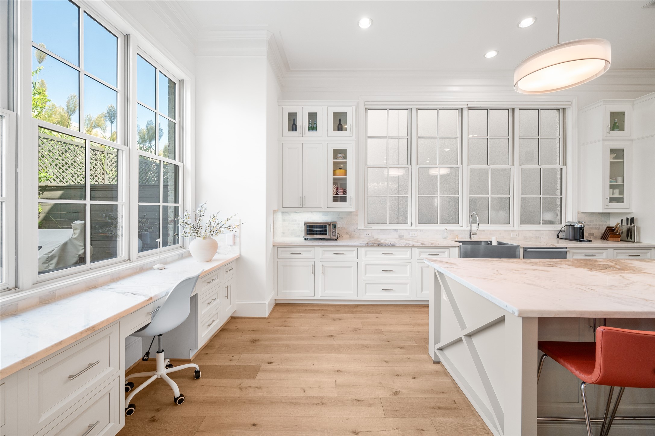 An additional kitchen perspective reveals a dedicated built-in workspace overlooking the backyard, complemented by generous counter space and natural light.