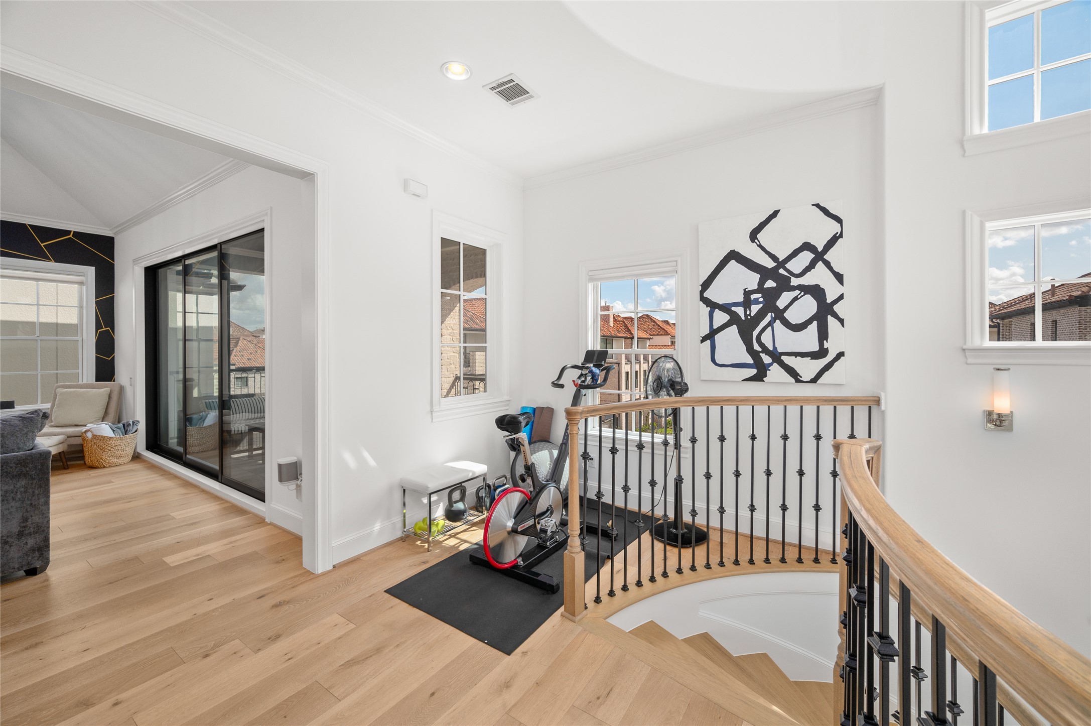 Comfortable secondary living area with expansive sliding glass doors opening to a covered balcony.