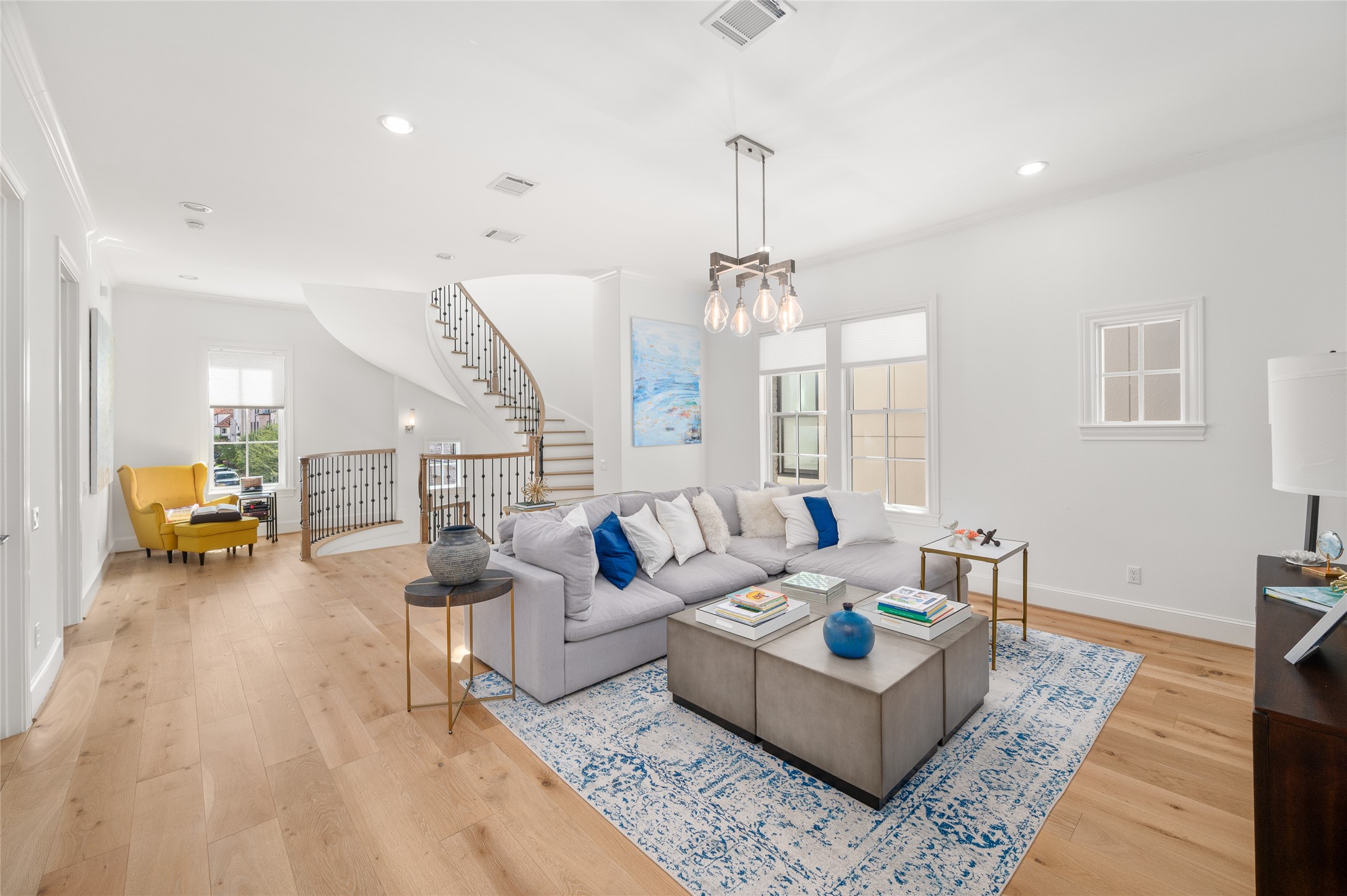 Open and comfortable gathering space with generous natural light, hardwood floors, and ample room for seating.