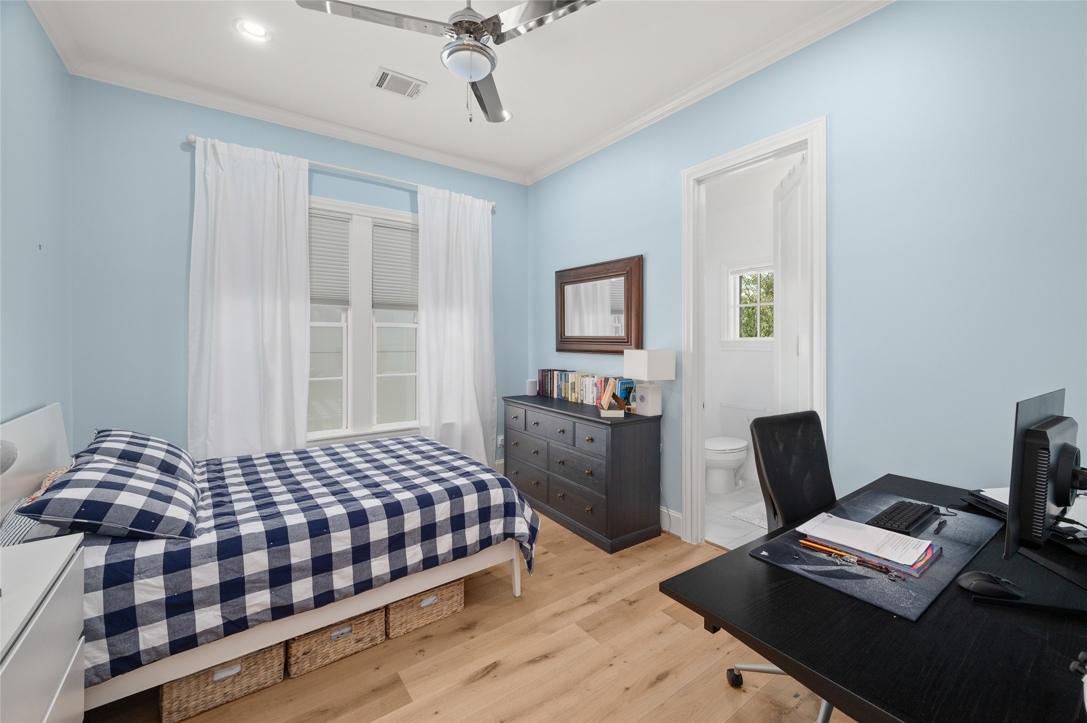 Secondary bedroom with en-suite bathroom and windows.