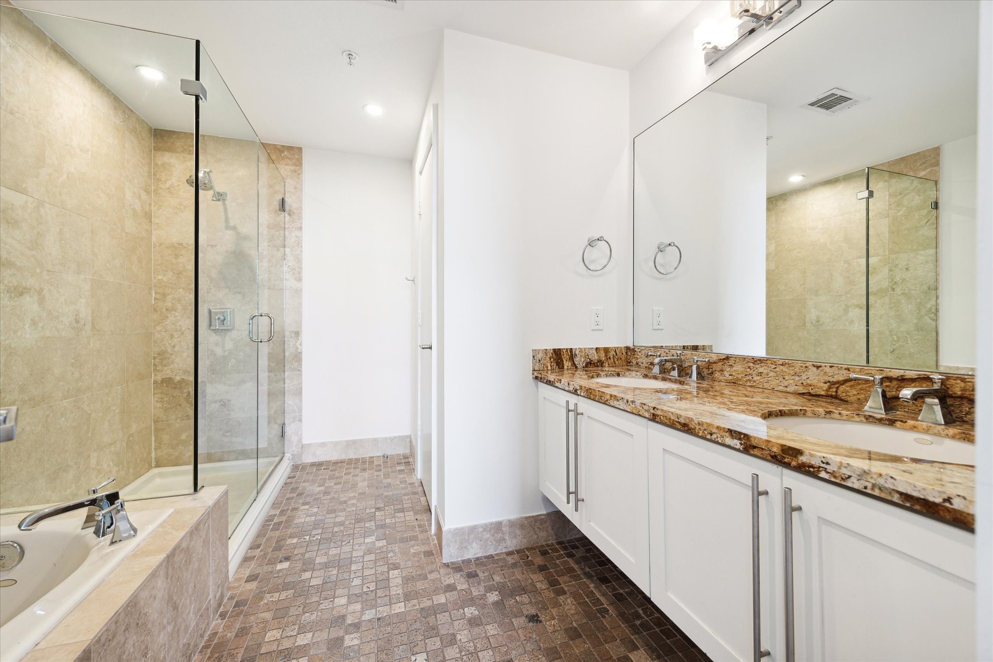 Primary bathroom with soaking tub and separate shower. Double sink vanity.