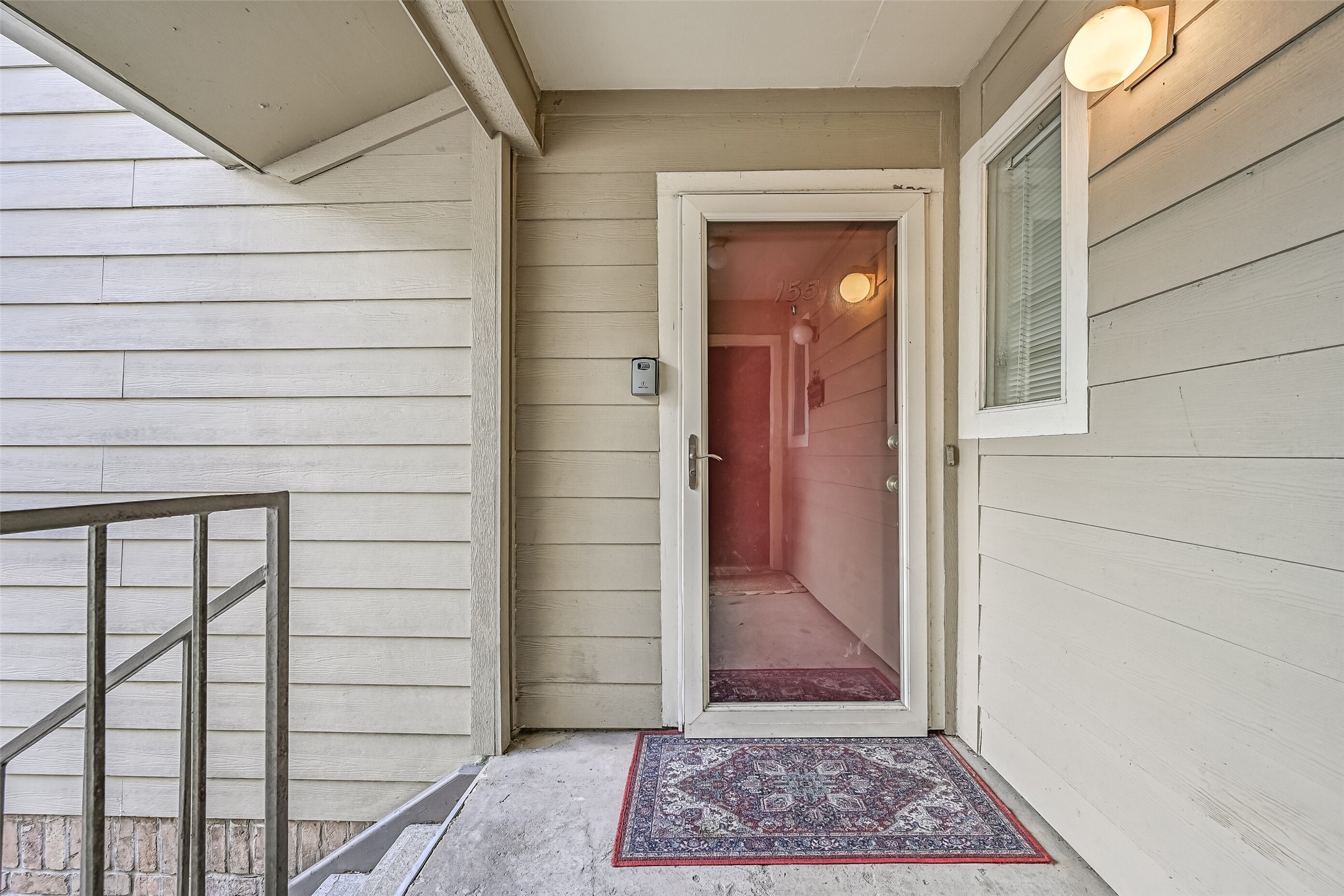 A covered second-floor entry welcomes you to Unit #155, with a storm door, exterior lighting & sheltered landing. Step inside to discover a spacious floor plan with wood-look flooring, neutral finishes & plenty of room to make yourself at home in this 2-bedroom condo.