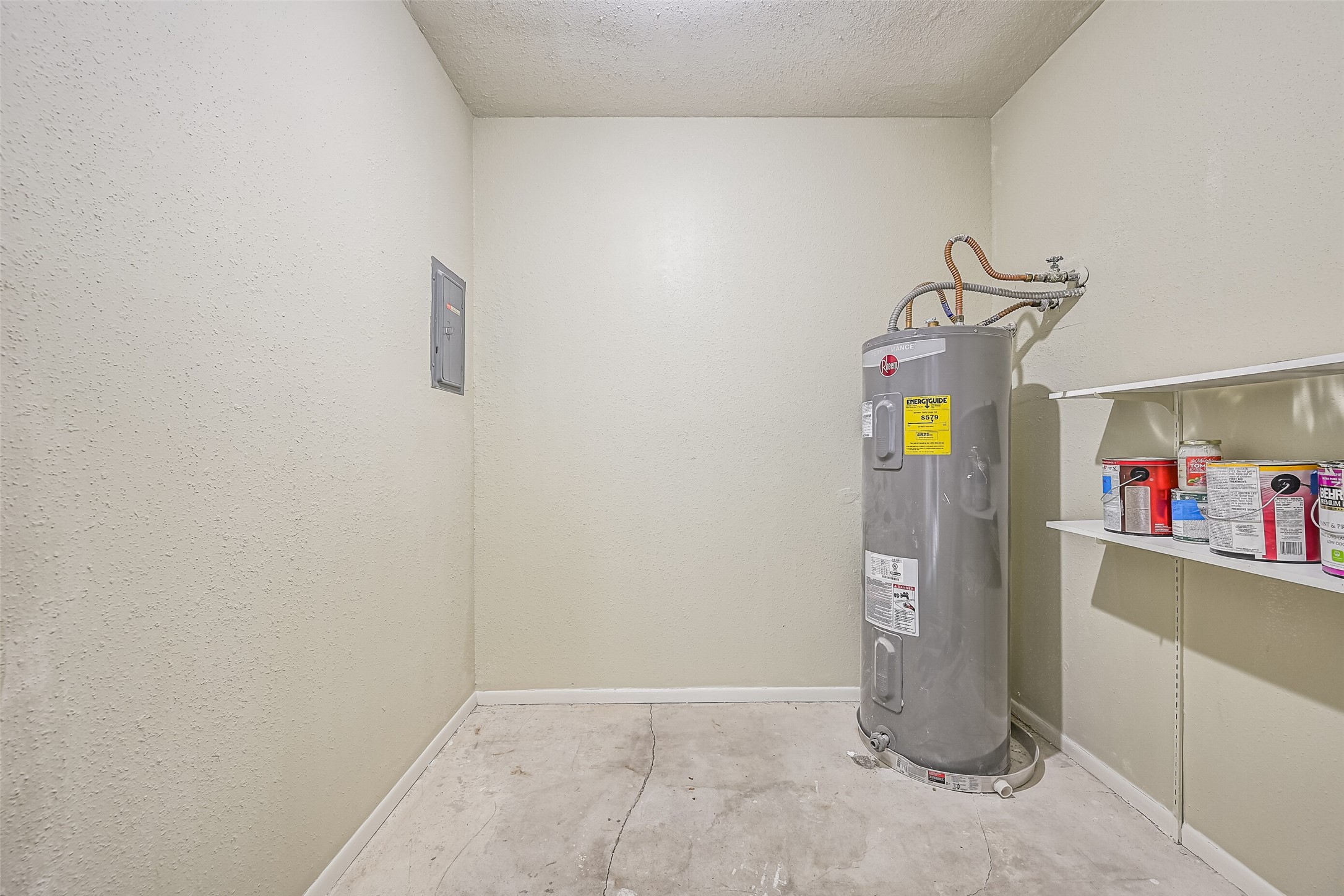 Located on the oversized covered balcony, this exterior storage closet offers additional space for seasonal items, household supplies & other belongings. Built-in shelving provides room for organization, while the water heater is tucked away here rather than occupying valuable interior living space.