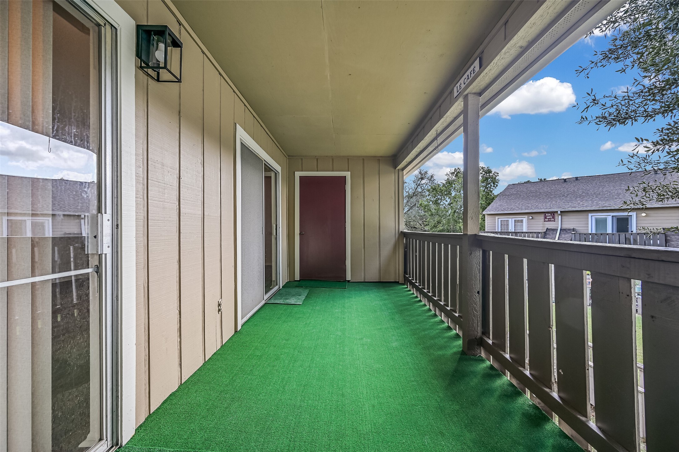 Step outside to an oversized covered balcony offering plenty of space for outdoor seating & relaxation! Accessible from the living & dining areas, this extended outdoor space features a protective roof overhead, open railings & an exterior storage closet at the far end for added functionality.