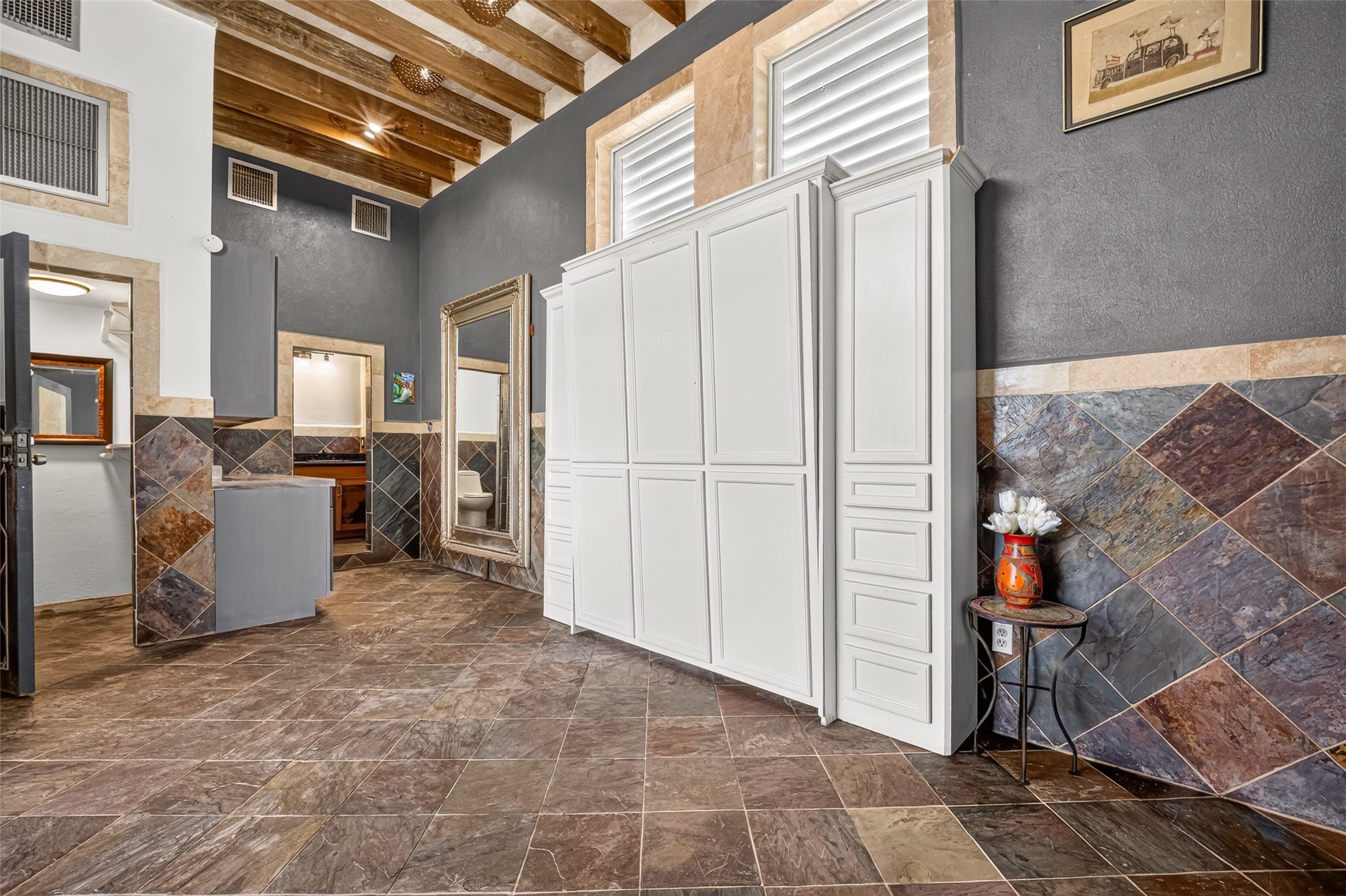 Tile floor and wall. Murphy Bed with side storage. Beamed ceiling. Unit designed for those who like simplicity.