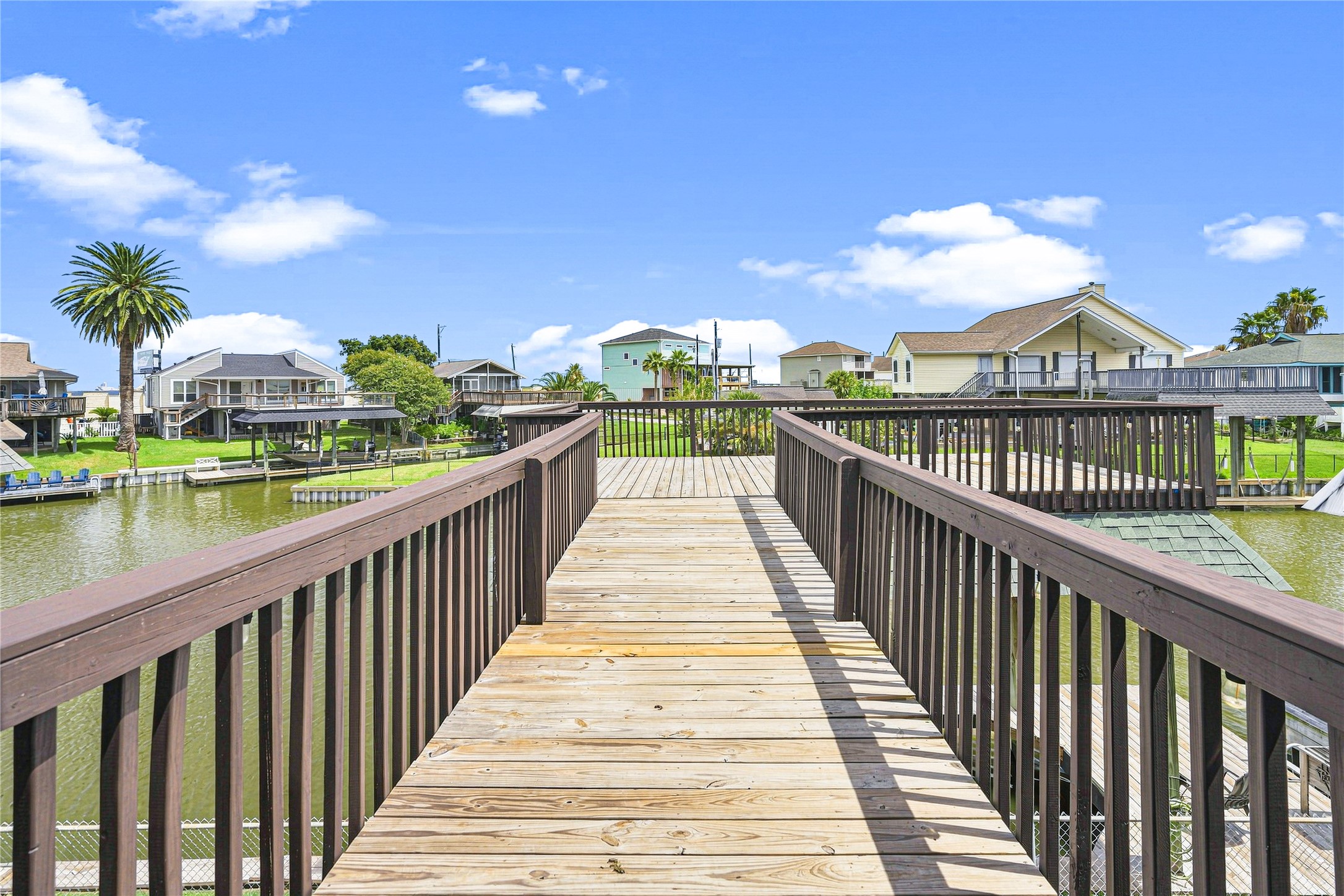 Expansive waterfront deck provides stunning canal views, perfect for relaxation in serene surroundings.