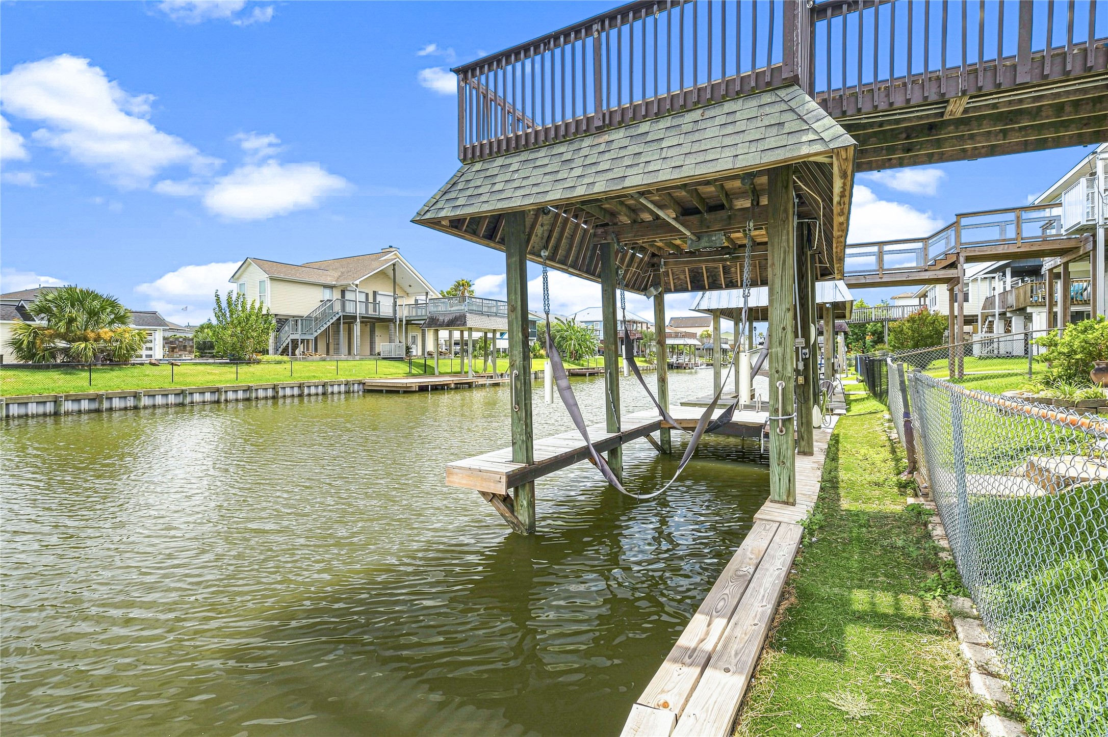 Waterfront property with a private boat lift and dock, offering serene canal views and easy access for boating enthusiasts. Ideal for enjoying outdoor living and quick waterway adventures.
