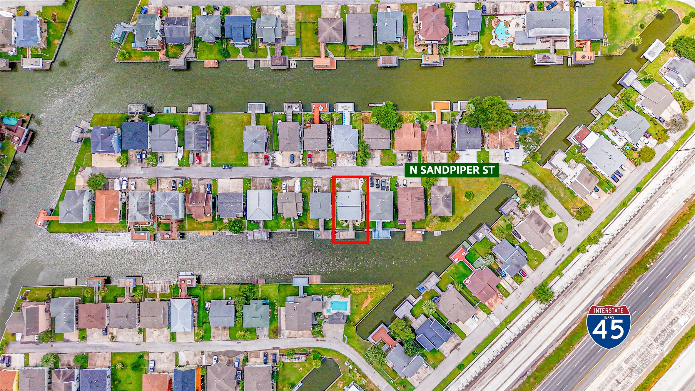 Charming waterfront home on N Sandpiper St, offering direct canal access and proximity to Interstate 45 for easy commuting.