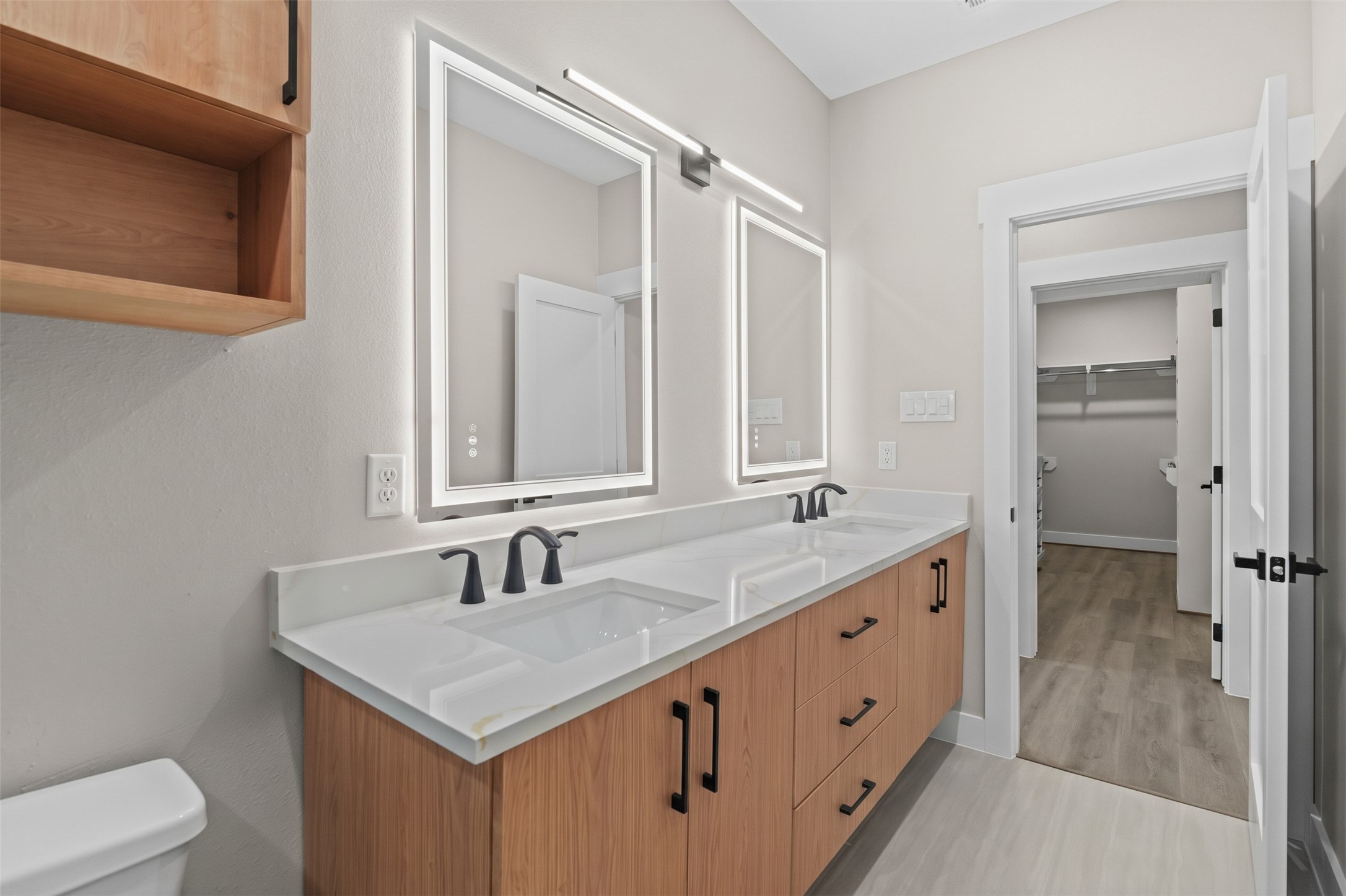 The functional floor plan offers excellent room clearance, seamlessly connecting the vanity zone directly to an adjoining walk-in closet.