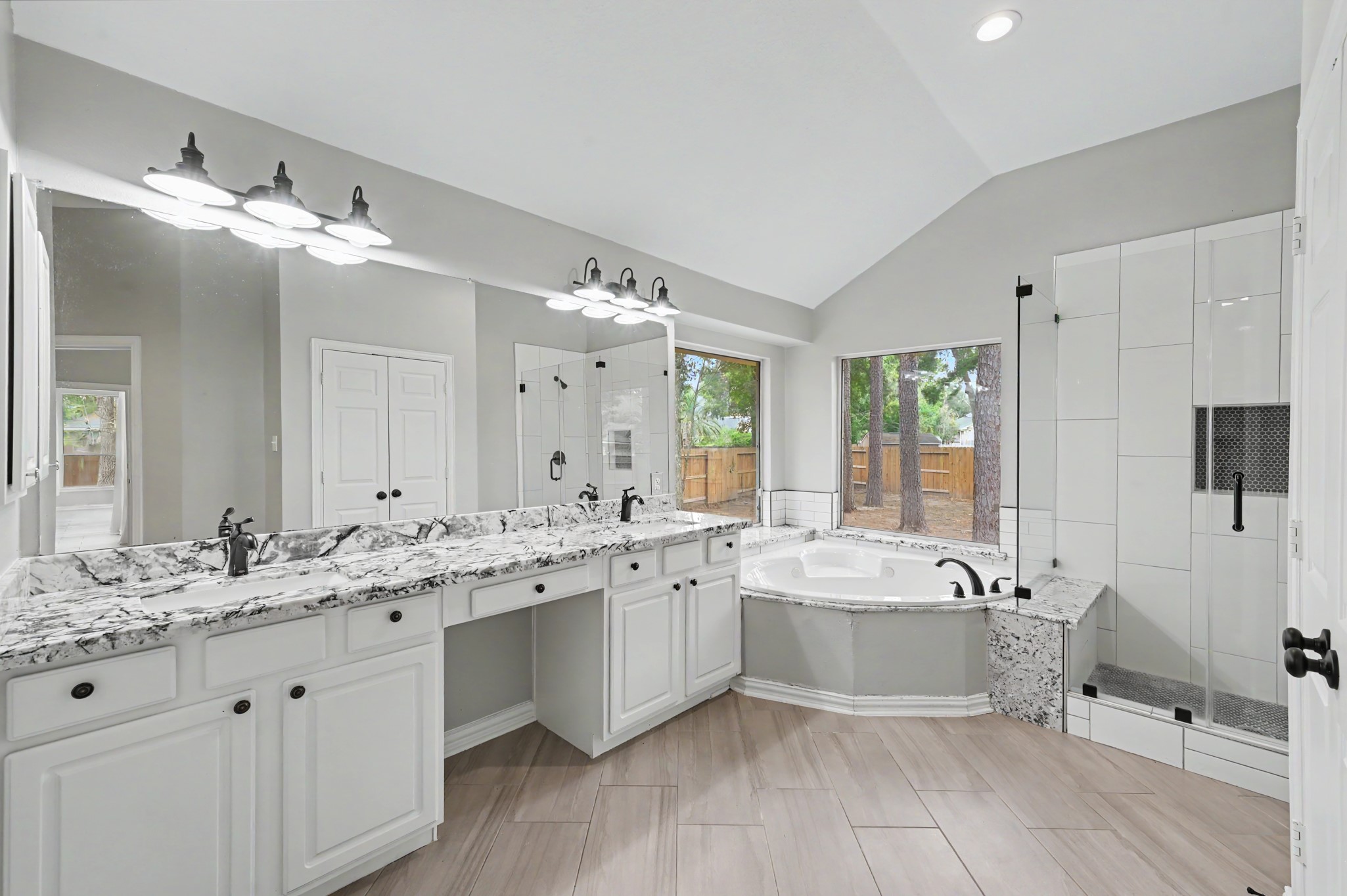 Luxurious and updated primary bathroom with jetted tub, separate shower and double vanity!