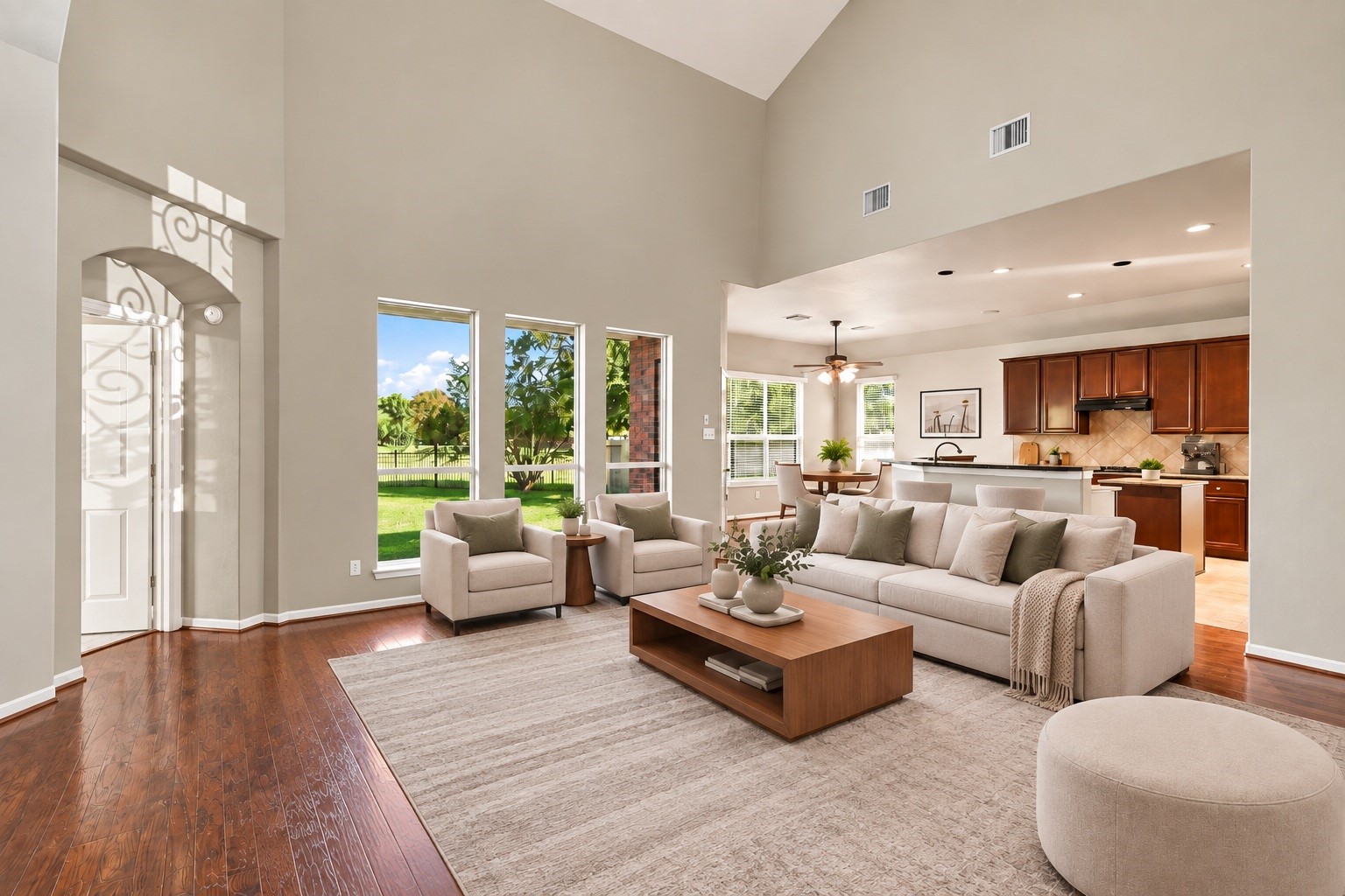 Virtually Staged: Tall windows line the main wall, filling the vast layout with natural light and providing uninterrupted views of the green backyard.