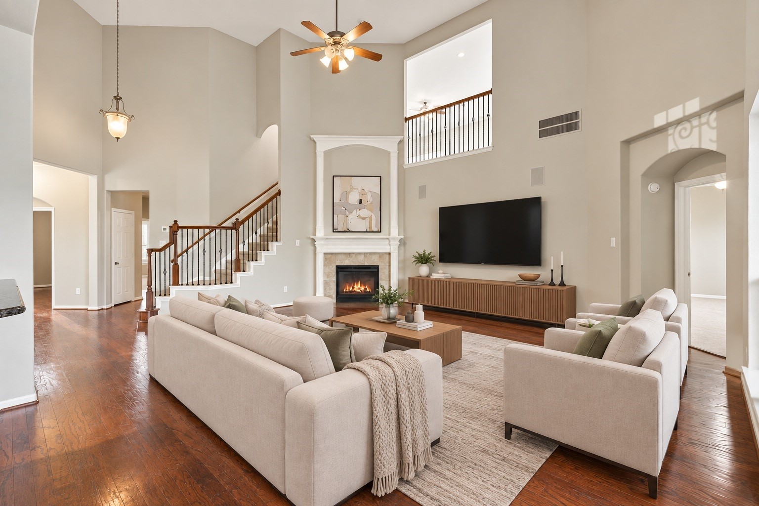 Virtually Staged: A central hearth serves as the rooms focal point, complemented by an open balcony look-through, wide walkways, and generous floor space ideal for versatile furniture arrangements.