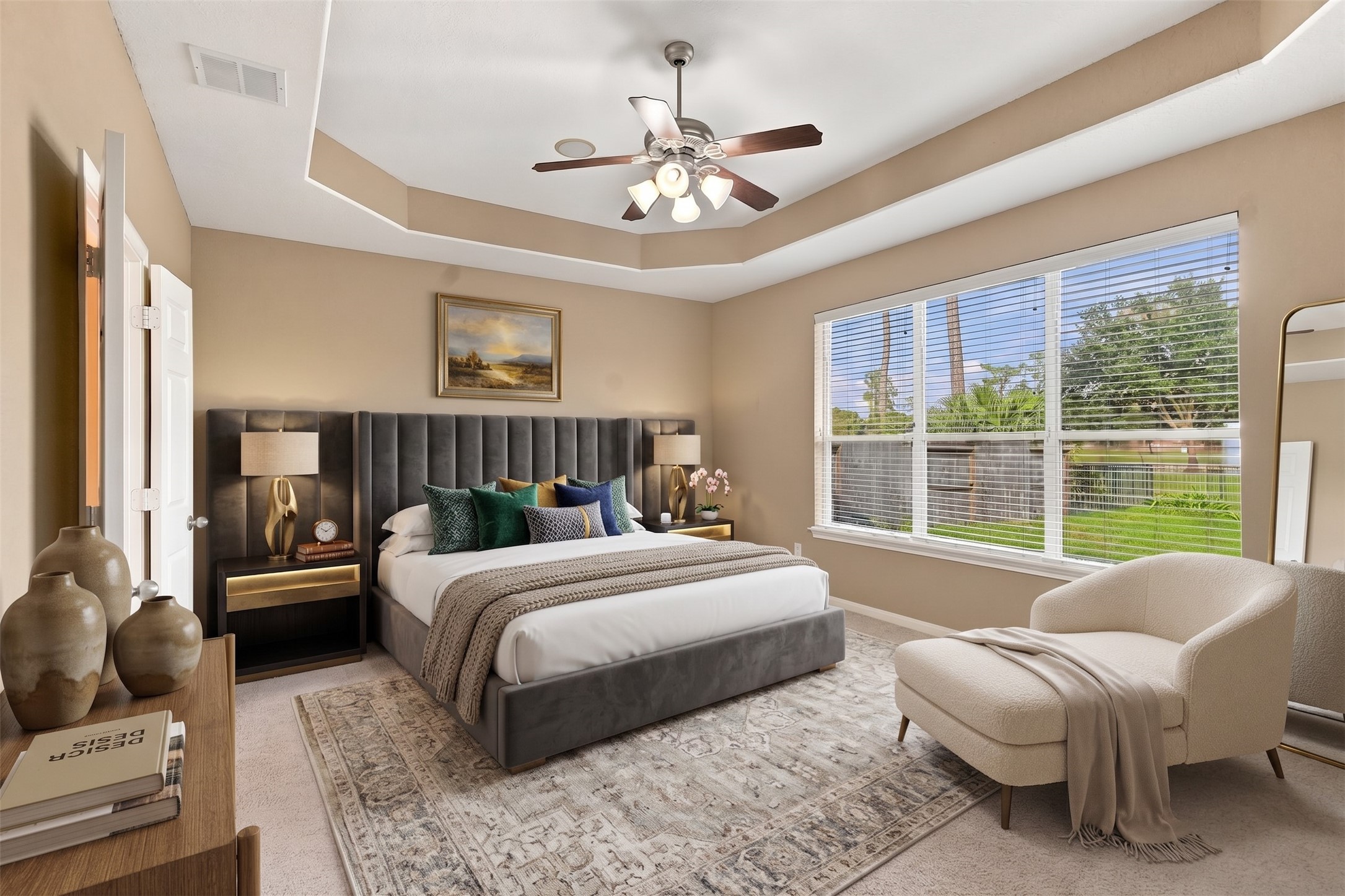 Virtually Staged: This spacious primary suite features a tray ceiling detailed with crown molding and a central light fixture with a ceiling fan. A expansive wall of windows brings in natural light and views of the backyard.