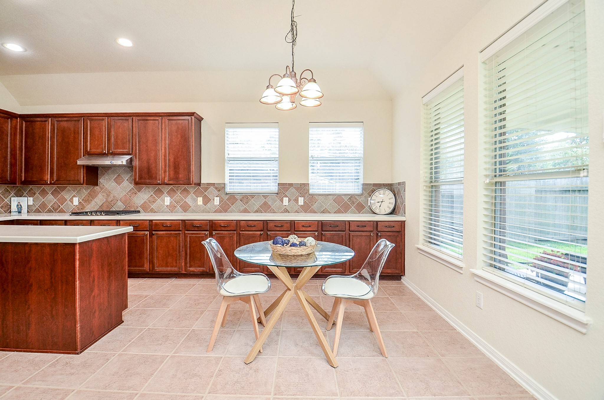 Morning coffee, homework at the table or a casual dinner all fit naturally here. The kitchen offers an abundance of cabinetry and counter space with a sunny breakfast area just steps away.