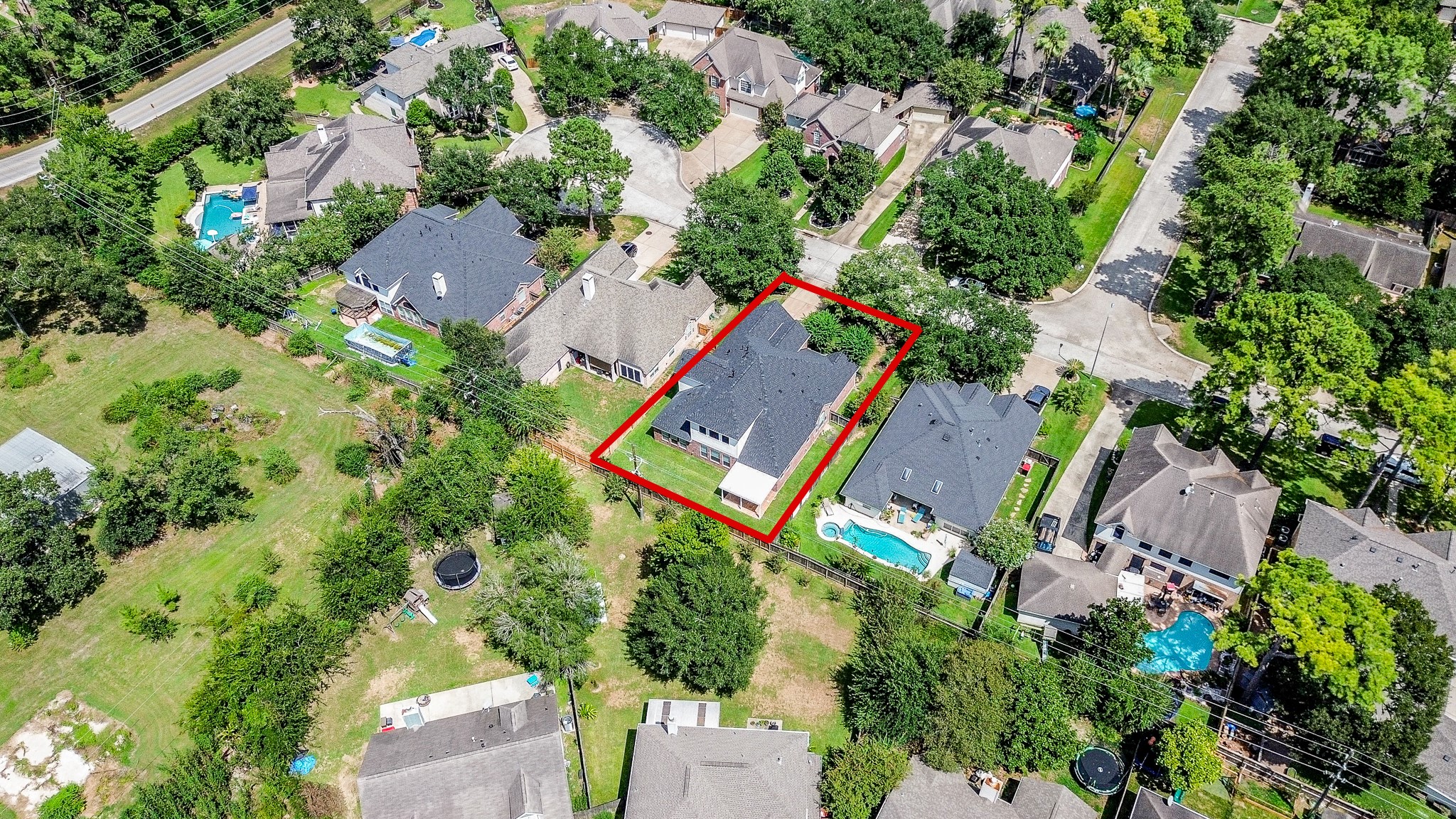 A birds-eye view puts the property into perspective, highlighting its setting among tree-lined streets and established homes in Northlake Forest.