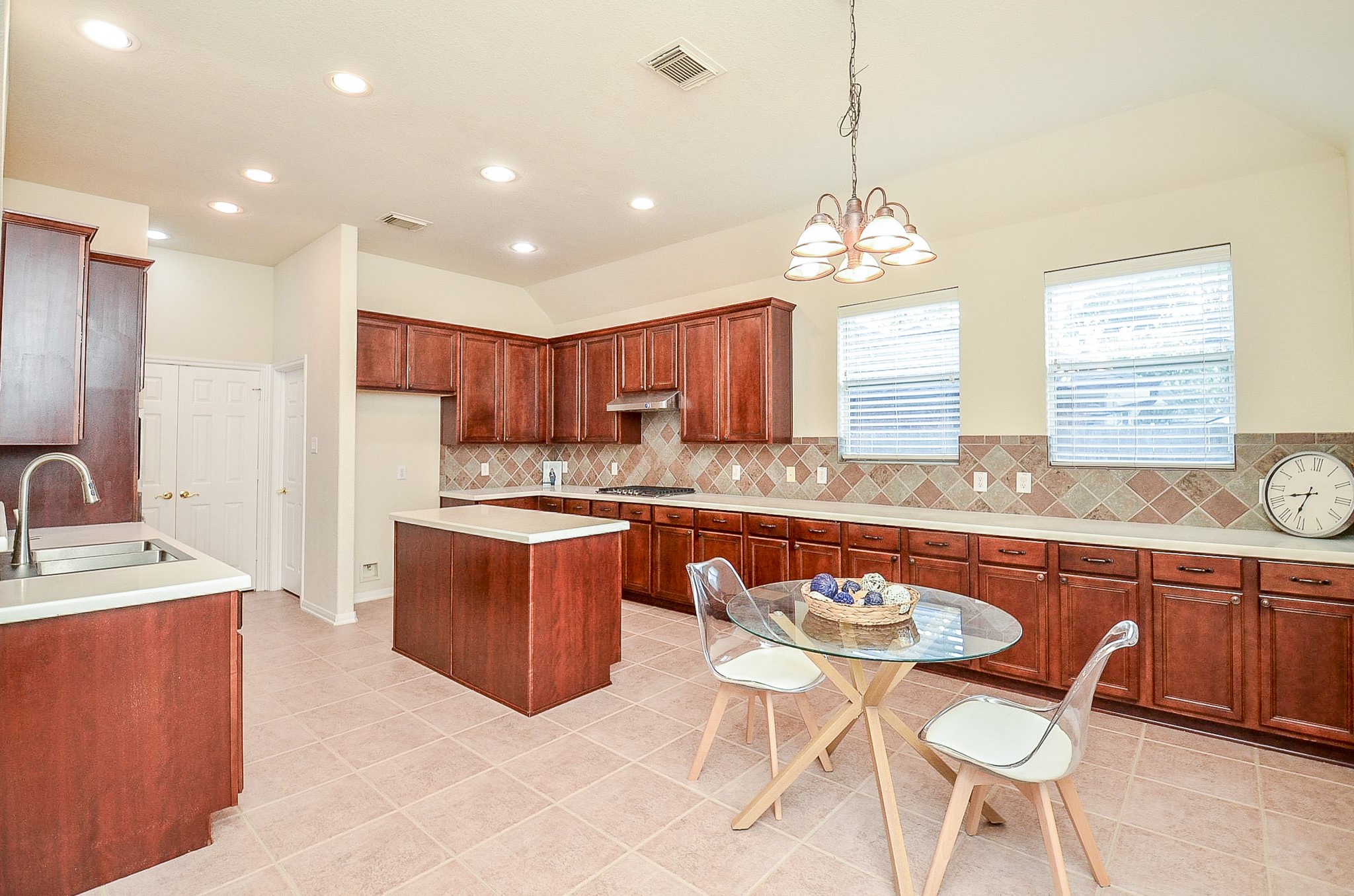 No disappearing into the kitchen when everyone else is gathered together. The wide opening keeps the kitchen connected to the family room, while the island provides additional workspace and storage.