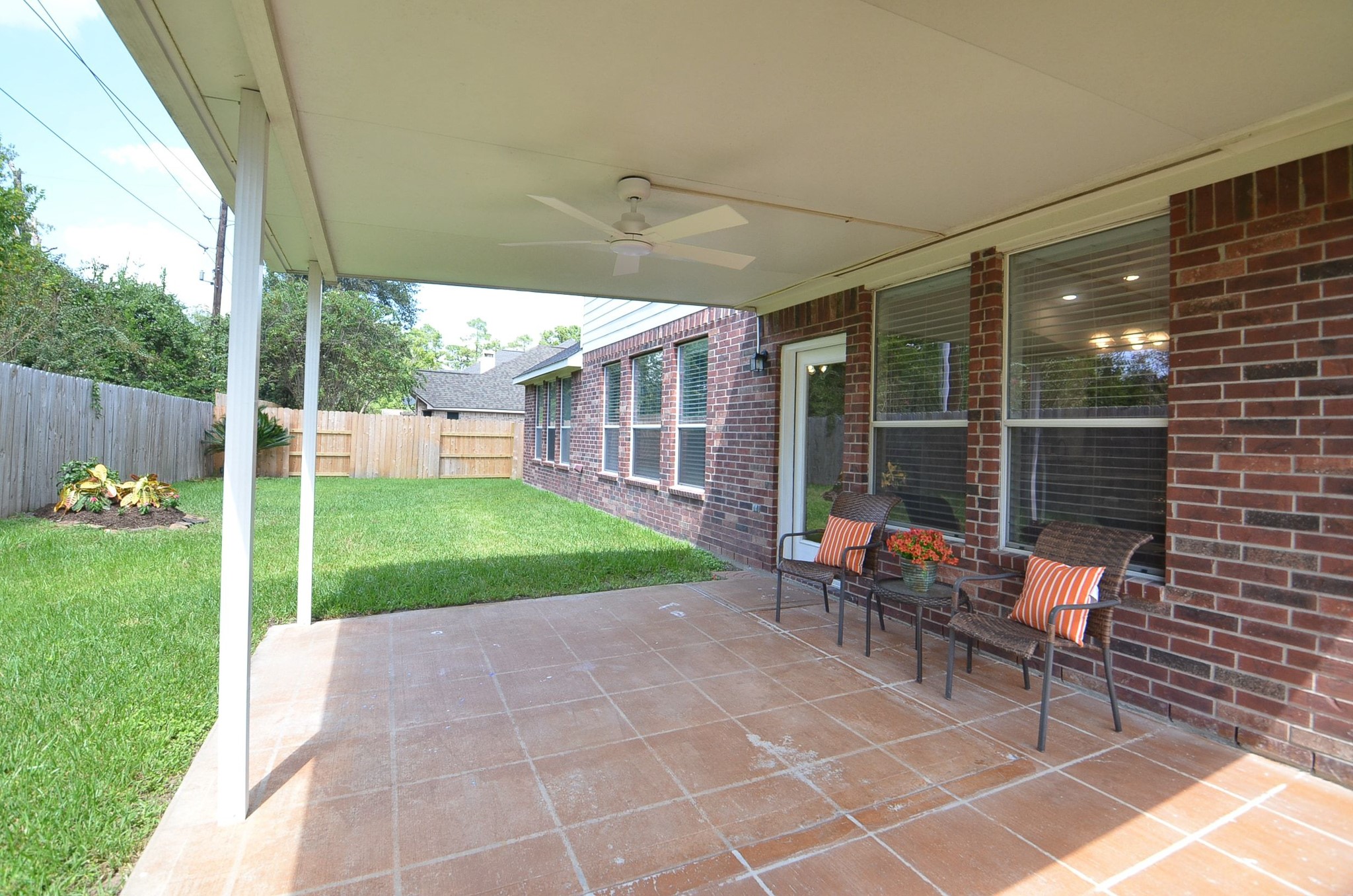 This is where the backyard becomes part of everyday living. The generously sized covered patio offers plenty of room for outdoor seating and dining, with a ceiling fan overhead to make relaxing outside even more enjoyable.