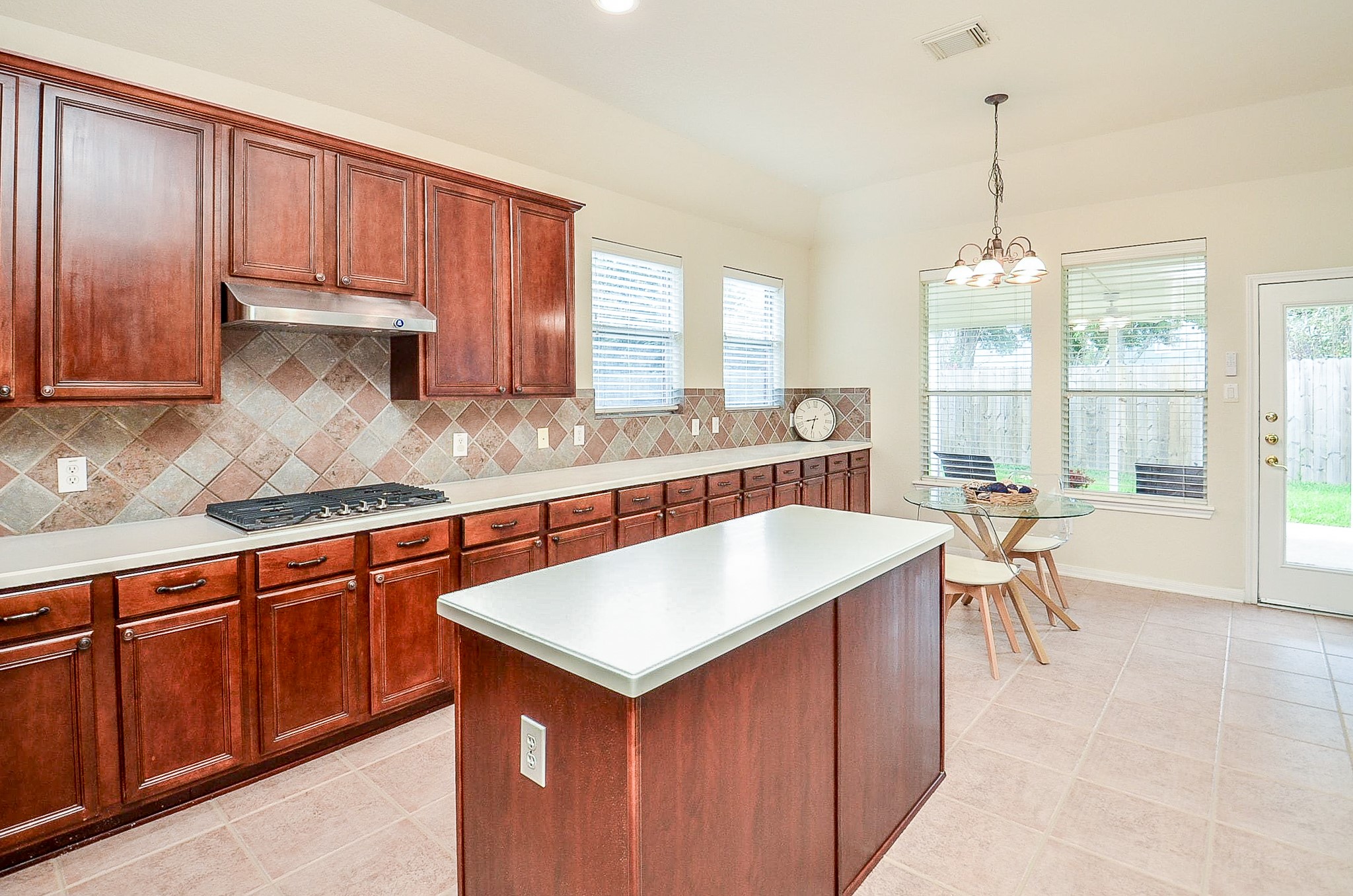 If kitchen storage is high on the wish list, this one delivers. An impressive run of cabinetry, generous prep space and a center island provide plenty of room for cooking, serving and keeping everything organized.