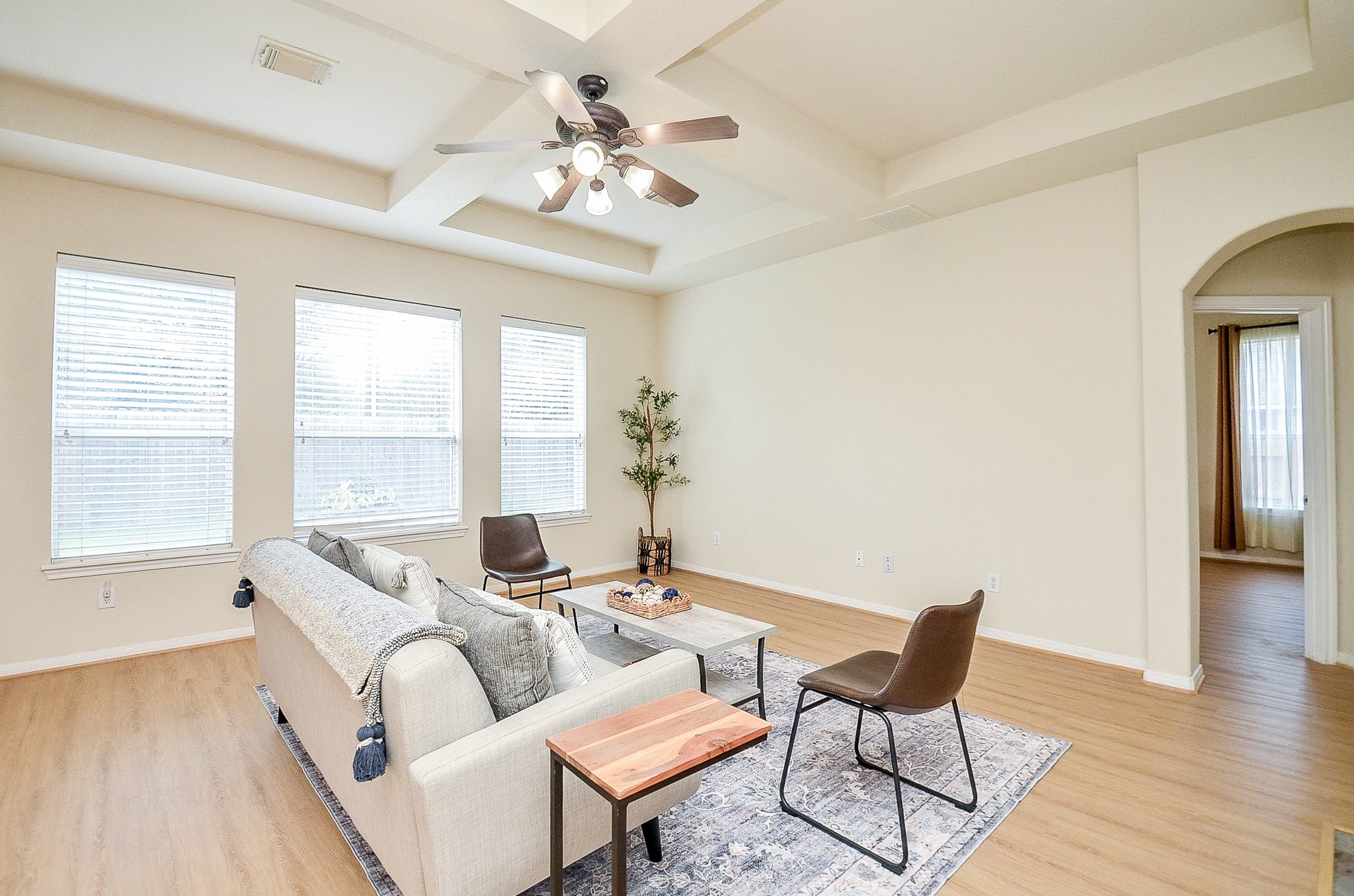 This is where everyday life can settle in. The spacious family room gives you room for a full seating arrangement, while three large windows bring in natural light and the detailed ceiling adds character overhead.