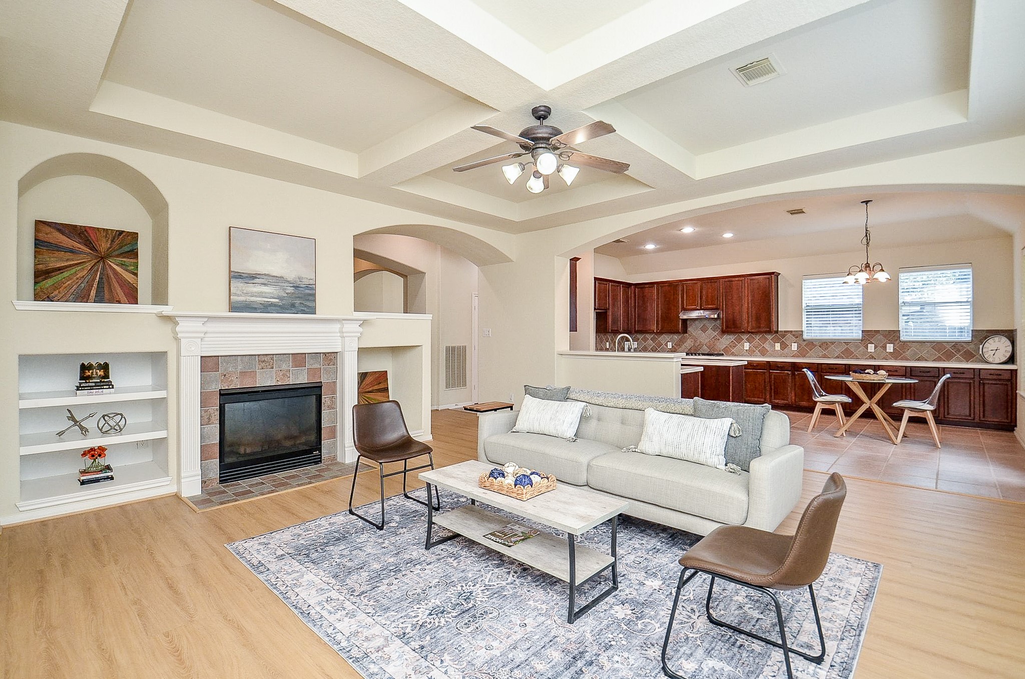 The heart of the home brings everyone together. The spacious family room opens directly to the kitchen and breakfast area, with a fireplace, built-ins and architectural ceiling detail adding character to the everyday living space.