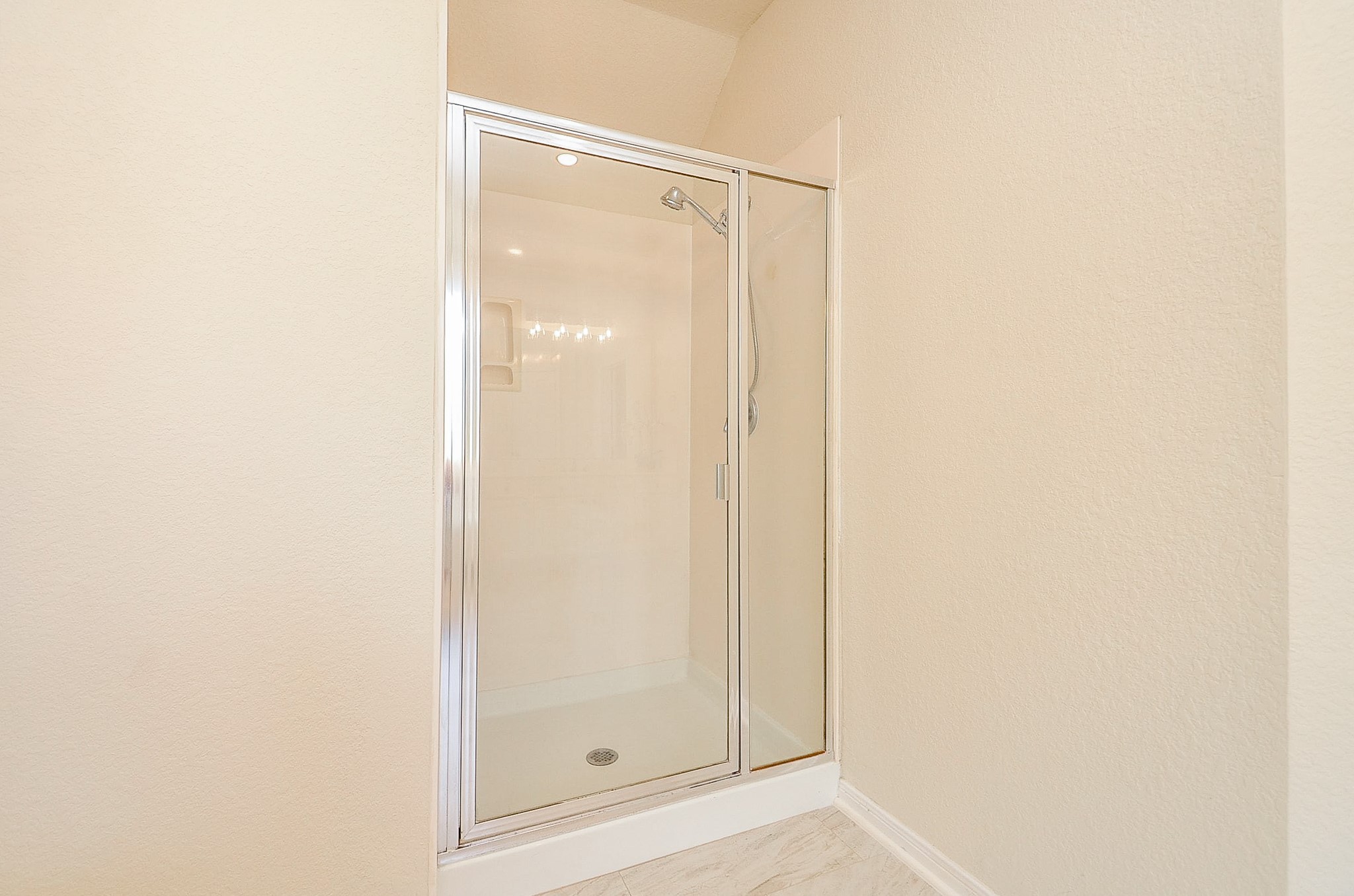 Prefer a quick shower to a long soak? The primary bath gives you both, with a separate enclosed shower tucked just beyond the main vanity area.