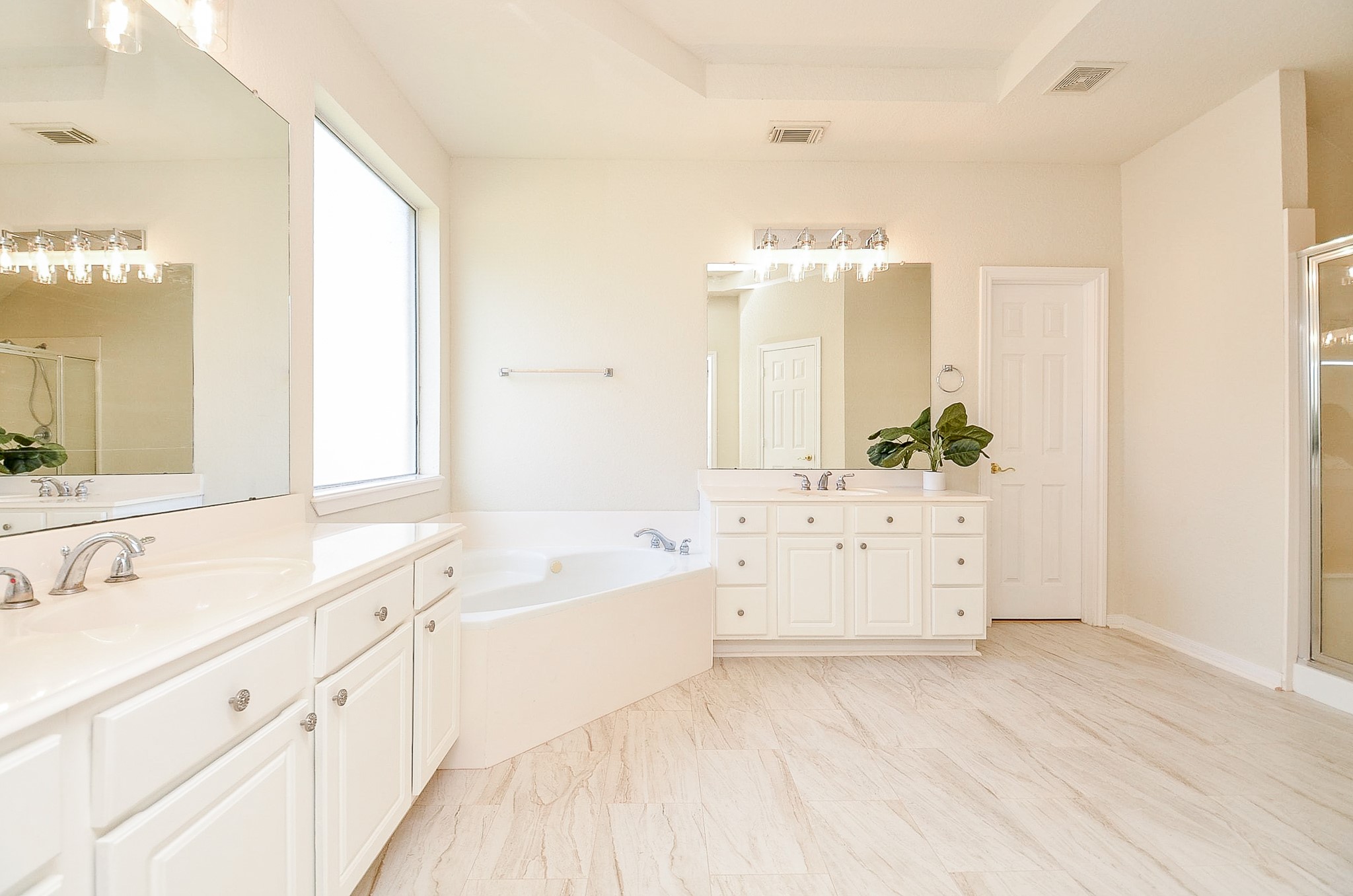 Two vanities mean two dedicated spaces, while the soaking tub and separate shower complete a primary bath that offers both function and room to move.