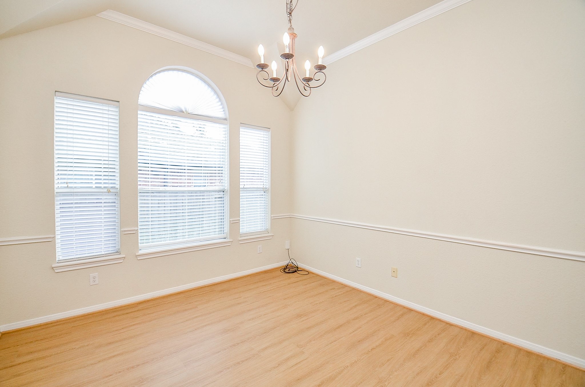 The vaulted ceiling, oversized windows and architectural detailing give the dining room plenty of presence without feeling closed off from the rest of the home.
