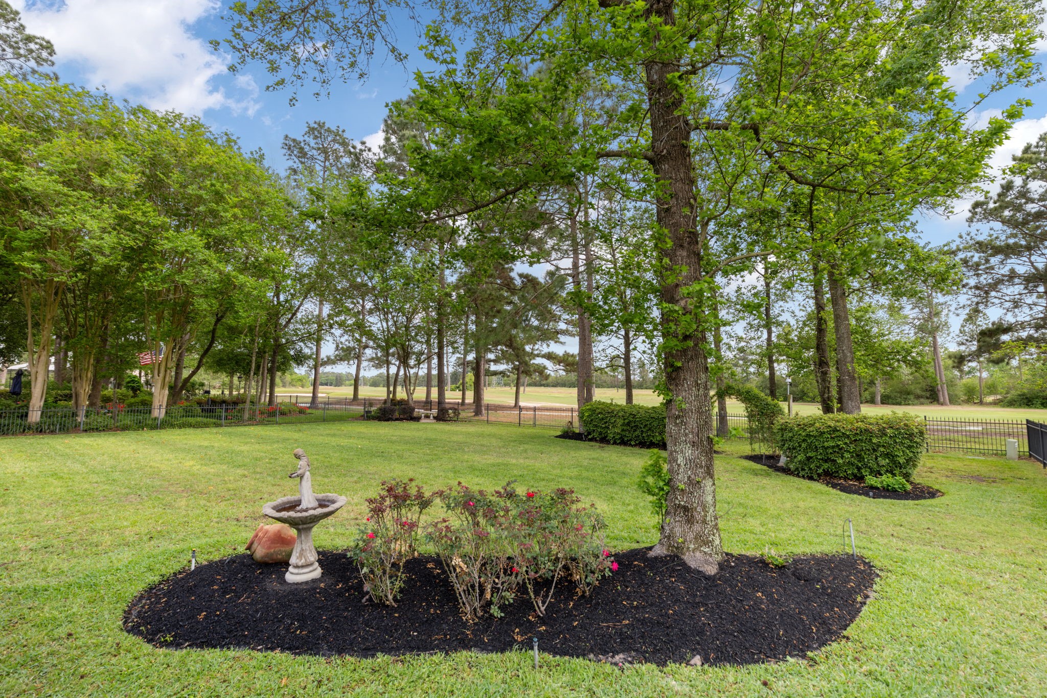 Mature trees and curated landscaping frame the backyard, adding beauty and shade to the outdoor experience. The large lot creates room for play, entertaining, and peaceful evenings outside.