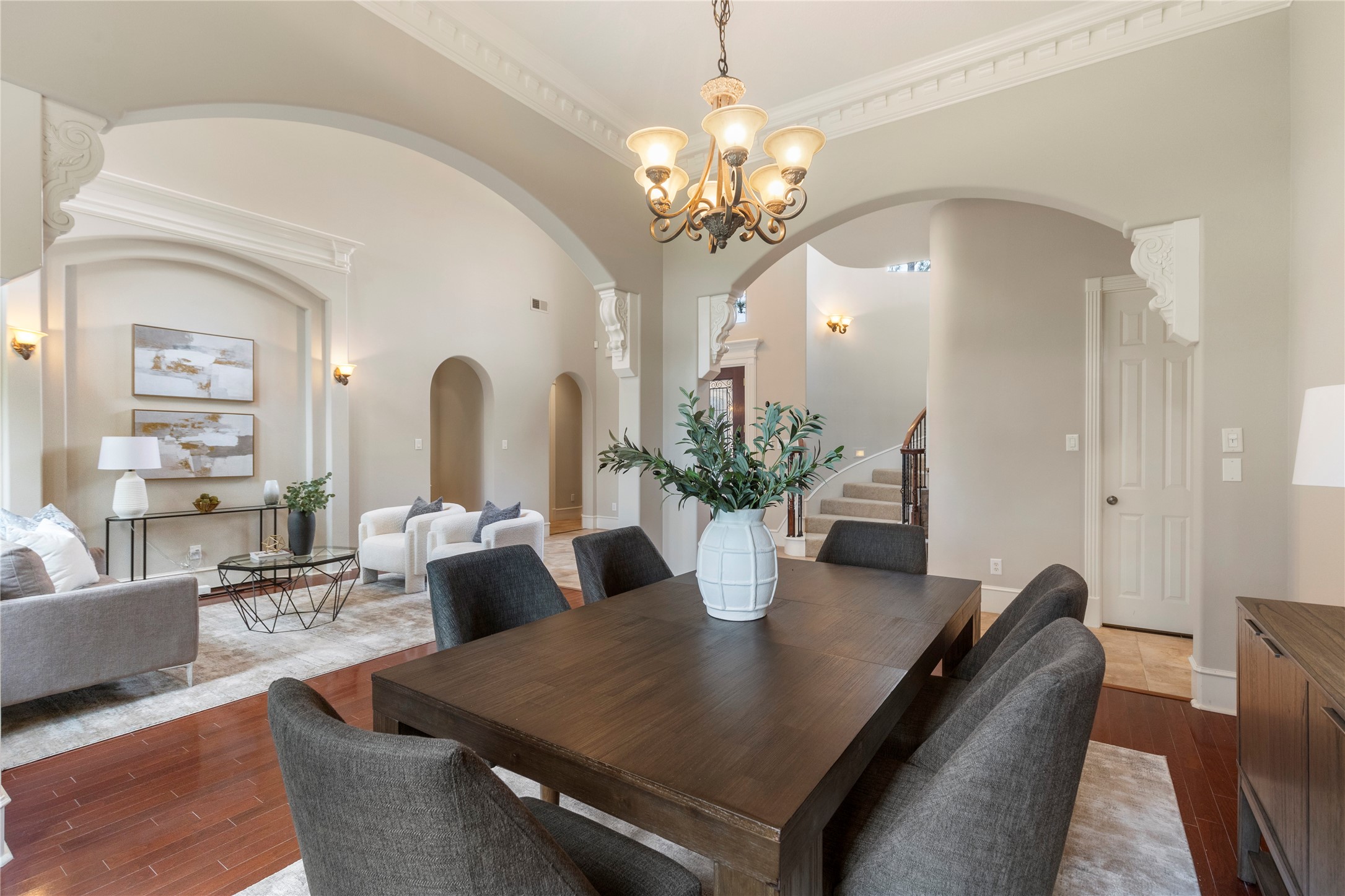 Graceful arches lead from the dining area toward the main living spaces, reinforcing the homes custom flow. The layout balances formal entertaining with comfortable everyday living.