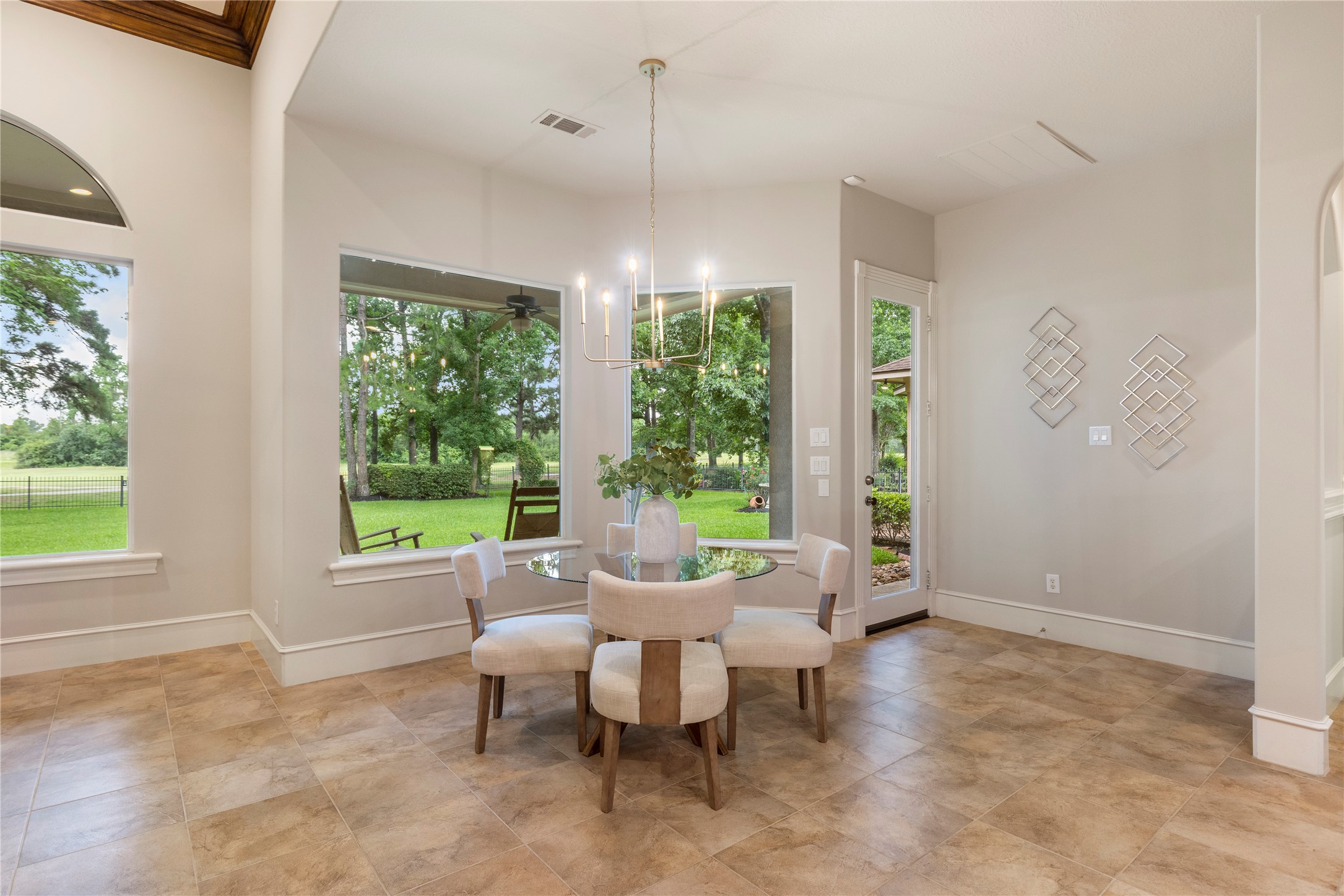A bright breakfast area overlooks the backyard and golf course, making everyday meals feel special. The views bring in a sense of calm while keeping the kitchen and den close by.