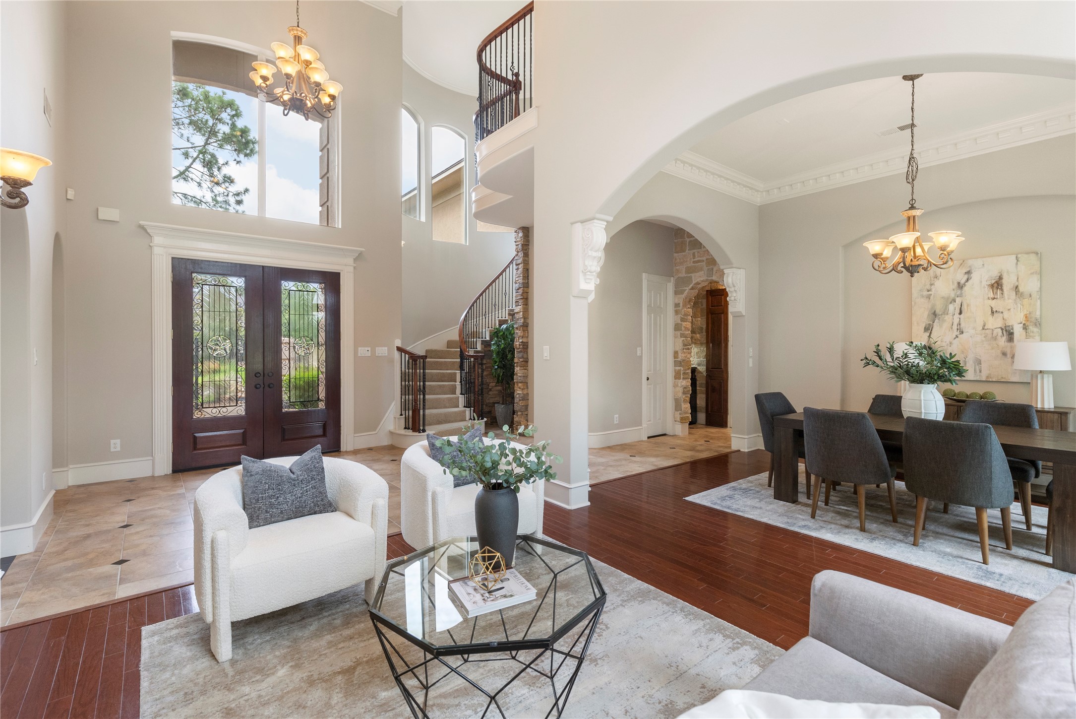 A soaring entry welcomes guests with two story ceilings, graceful architectural lines, and views that draw the eye through the home. The formal layout immediately feels elevated, polished, and designed for memorable first impressions.