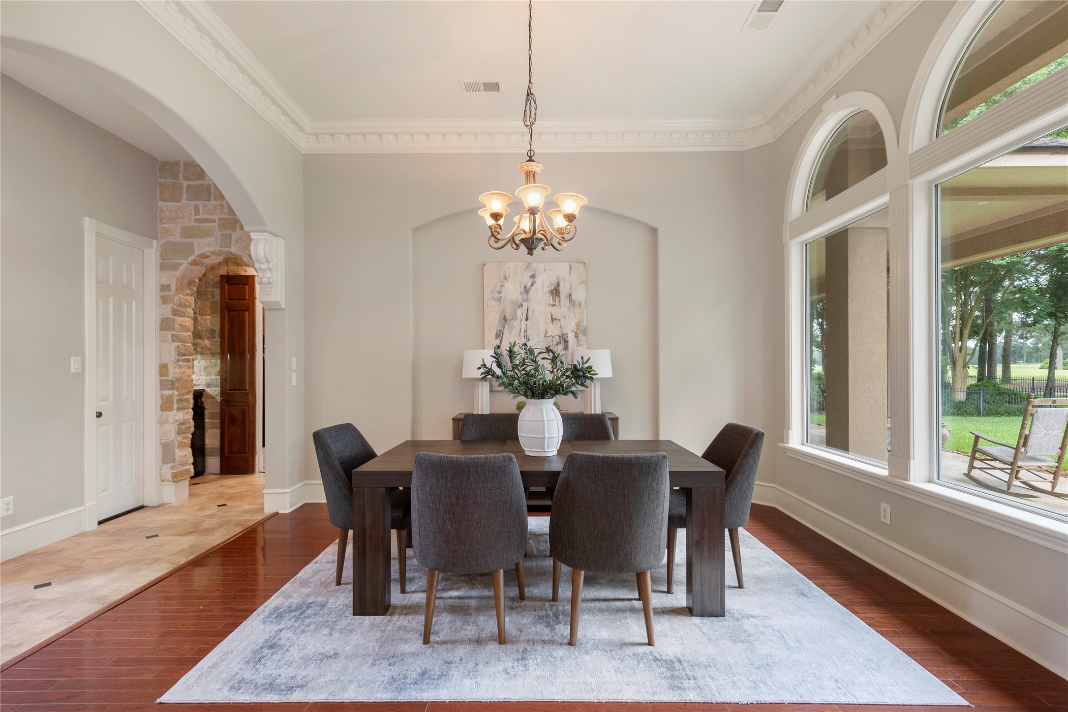 The formal dining room is framed by arched windows and generous ceiling height, creating a refined backdrop for holidays and special gatherings. Golf course views add a memorable layer to the dining experience. The formal dining room is framed by arched windows and generous ceiling height, creating a refined backdrop for holidays and special gatherings. Golf course views add a memorable layer to the dining experience.