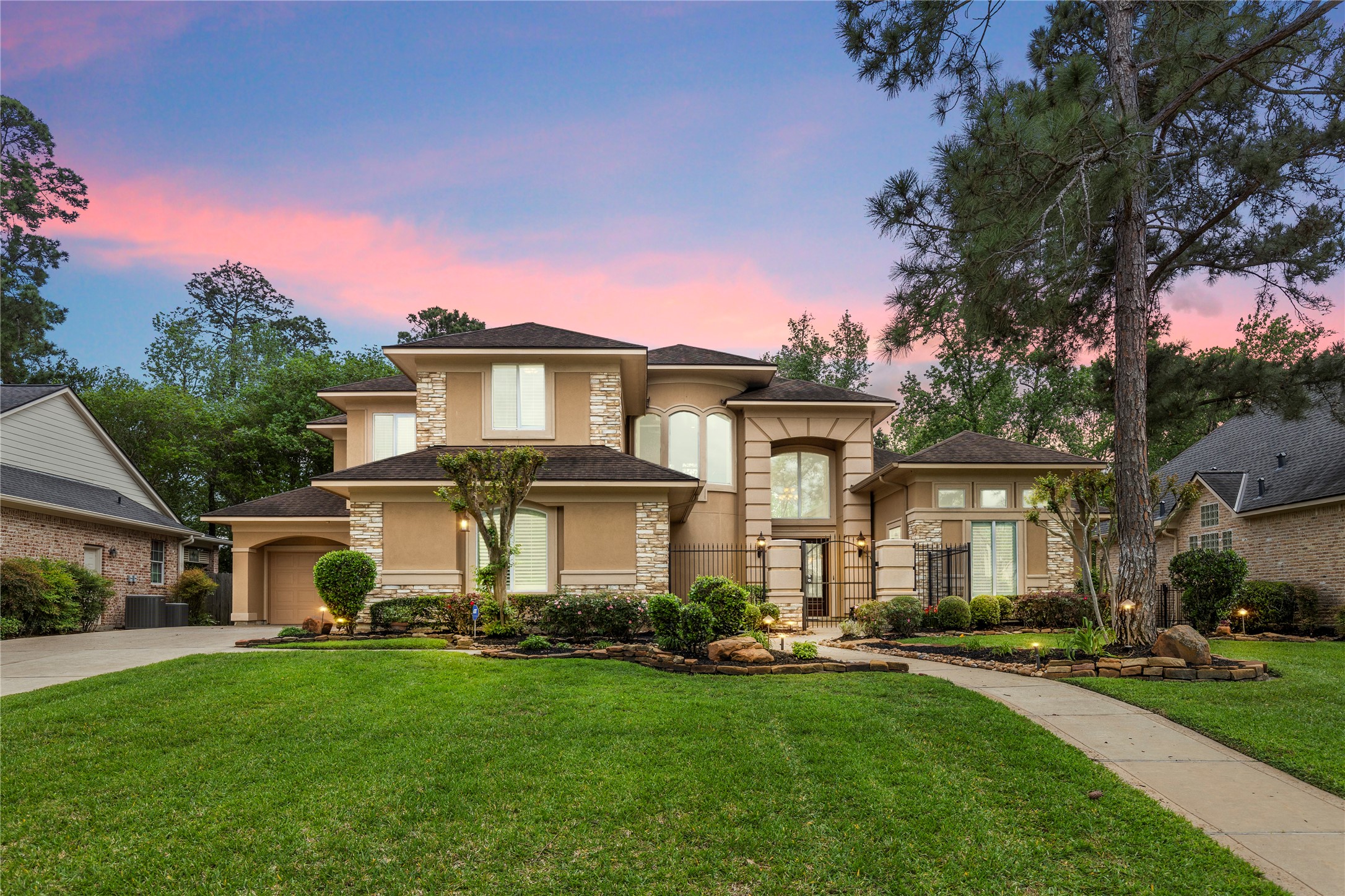 The front elevation at sunset captures the homes stately architecture and timeless presence. It is a fitting final image for a custom residence with grand interiors, epic views, and an exceptional Windrose location.