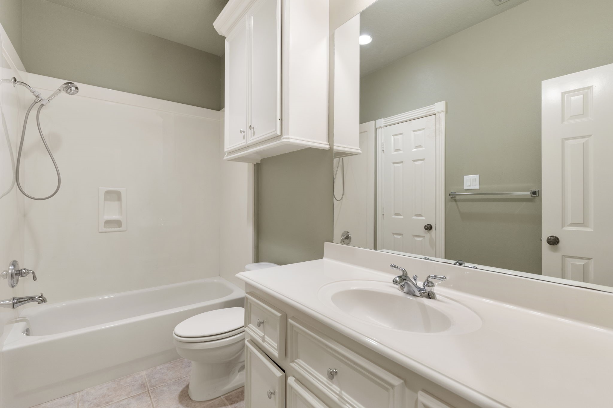 This bath view shows a tub and shower combination with convenient vanity space.