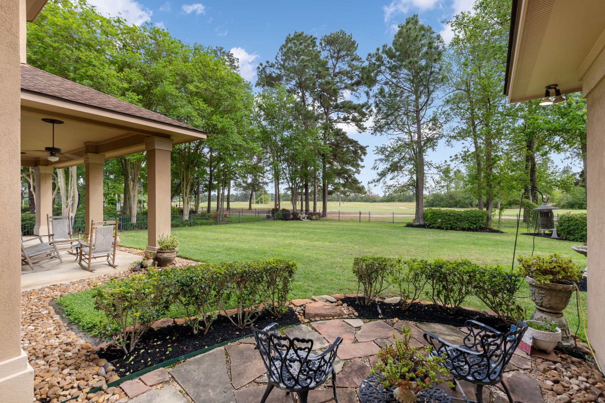 The flagstone corner patio creates another outdoor destination beyond the covered porch. It is a charming place to enjoy the fairway views and tree lined surroundings.