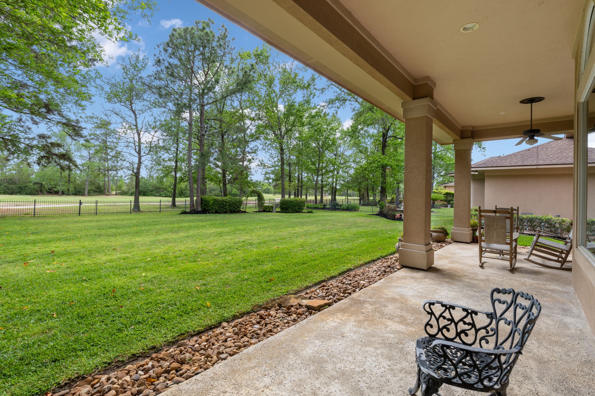 Another patio view shows the depth of the backyard and the open green space beyond. It is ideal for buyers who want privacy, scenery, and room to enjoy the outdoors.