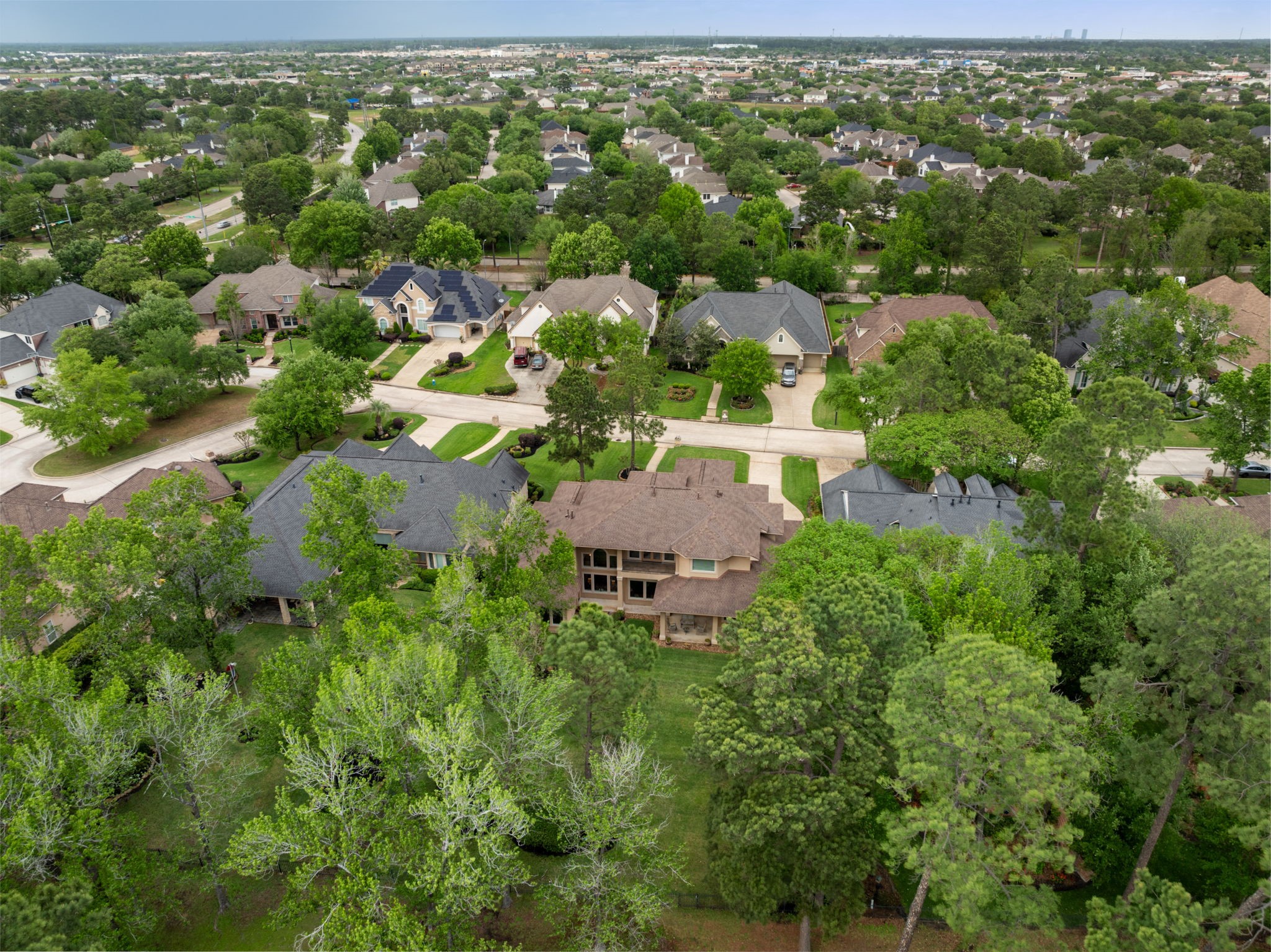 Aerial perspective highlights the homes placement within an established golf course community. The setting offers a tucked away feel while remaining close to daily conveniences.