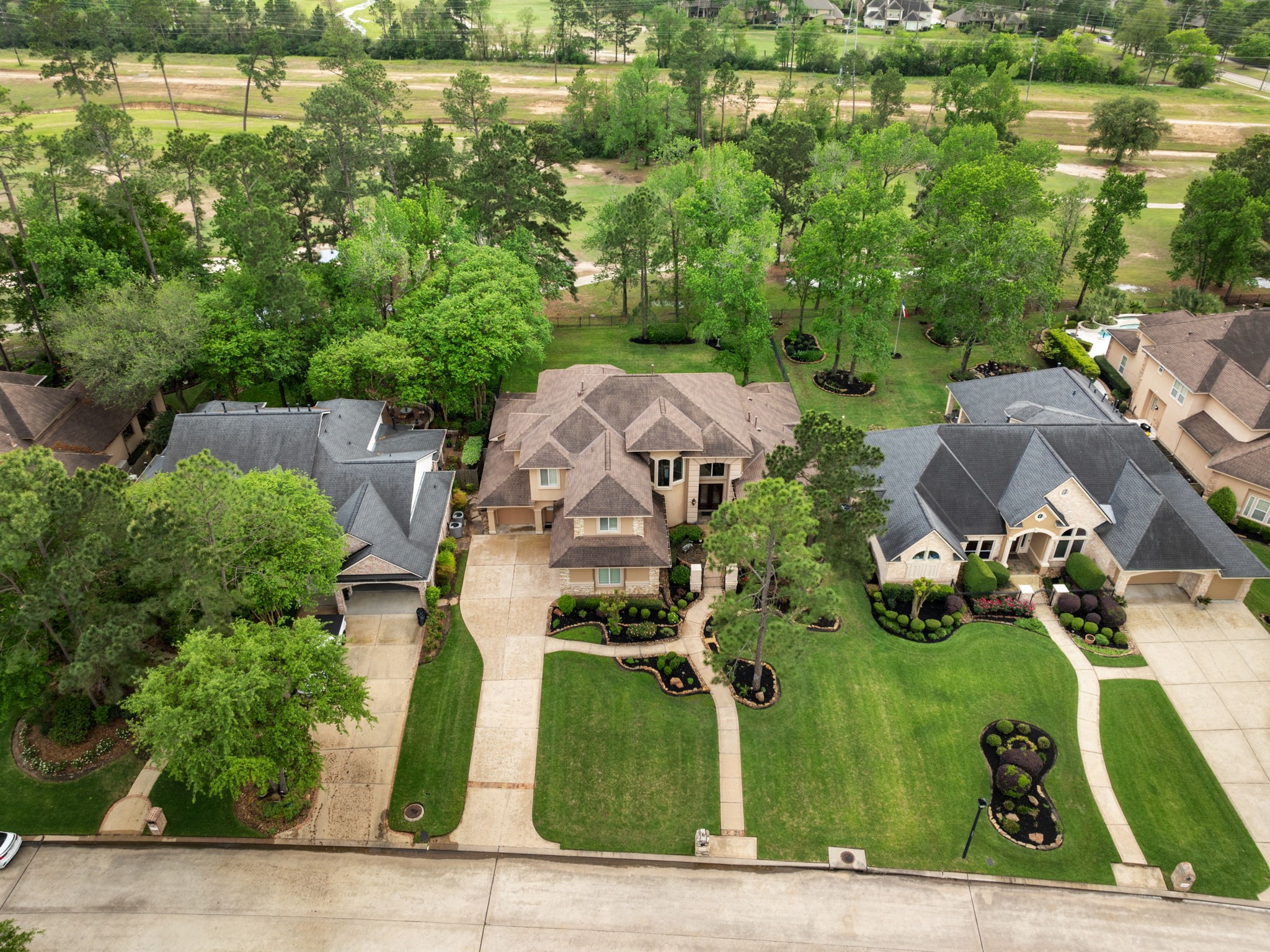 From above, the homes generous lot placement and sweeping driveway showcase the scale of the property. Large lot enables the home to sit back from the street and provides an extensive yard space for play and outdoor living.