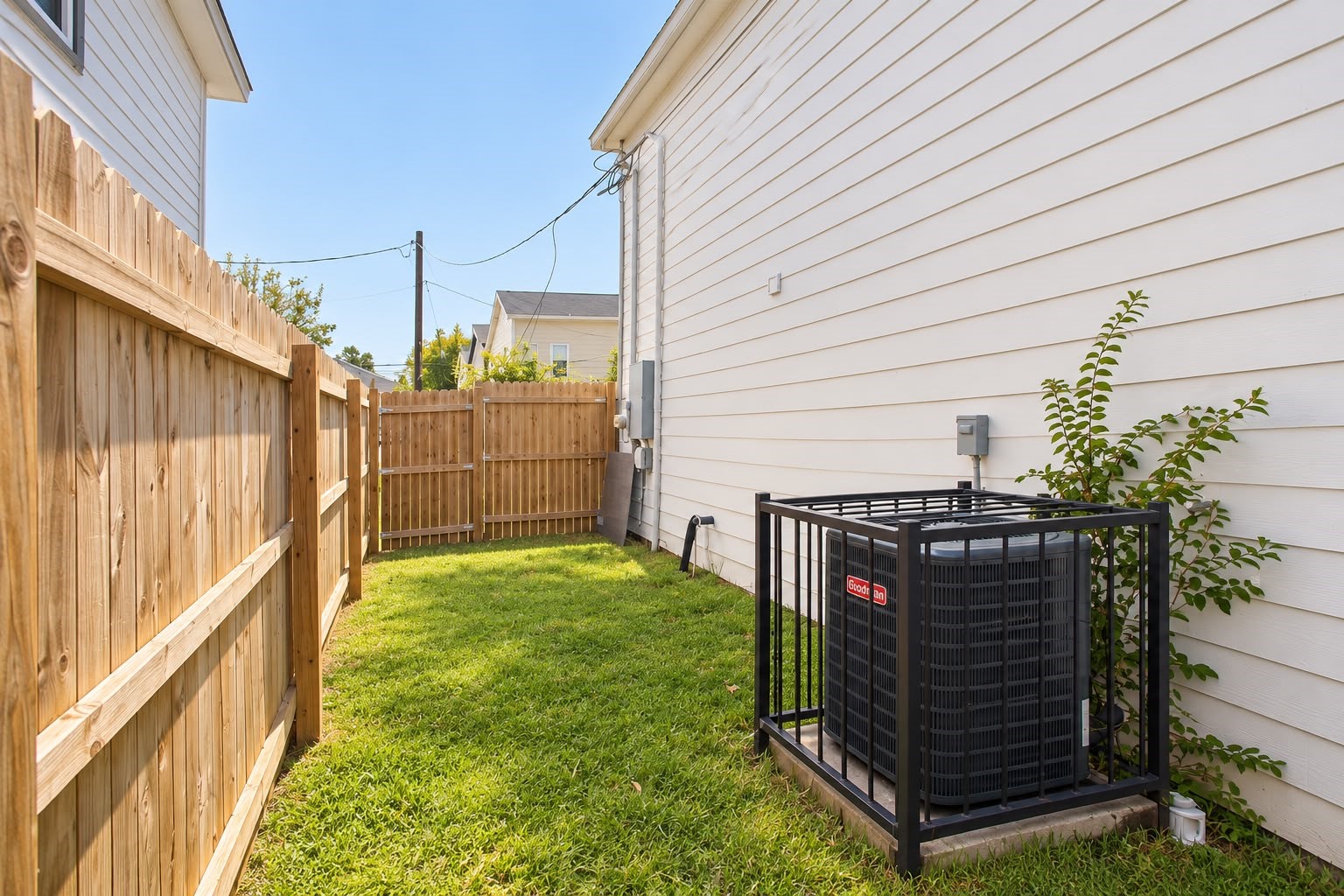 Fenced backyard with grass, great for pets and outdoor time.