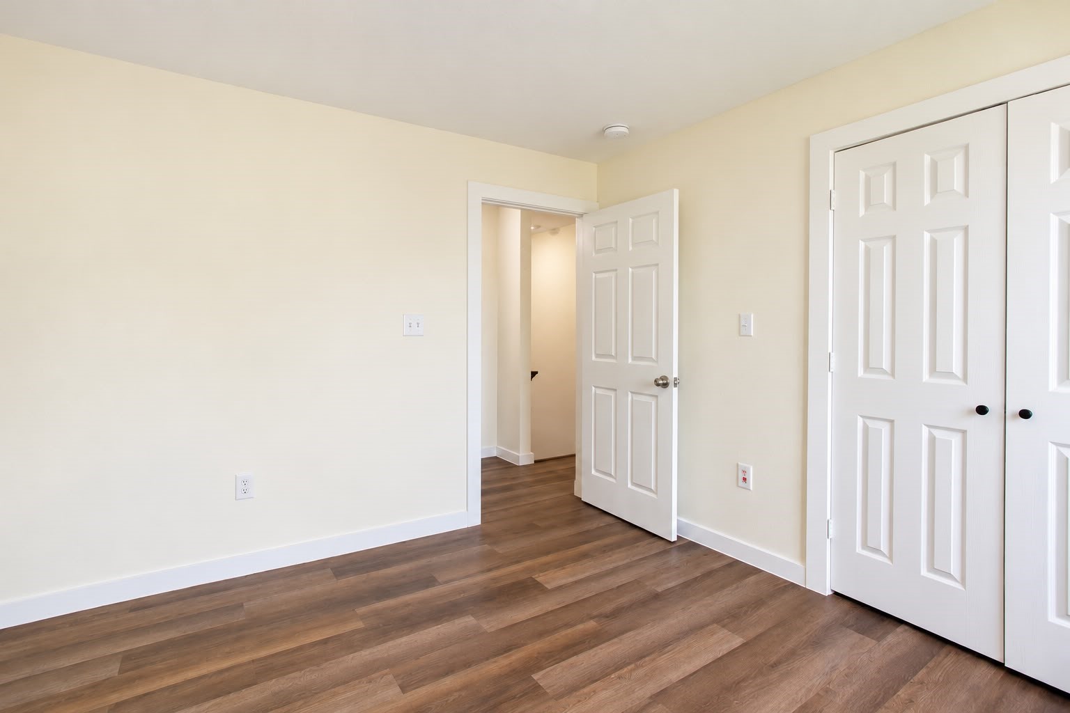 Bedroom with a double door closet and fresh neutral paint.