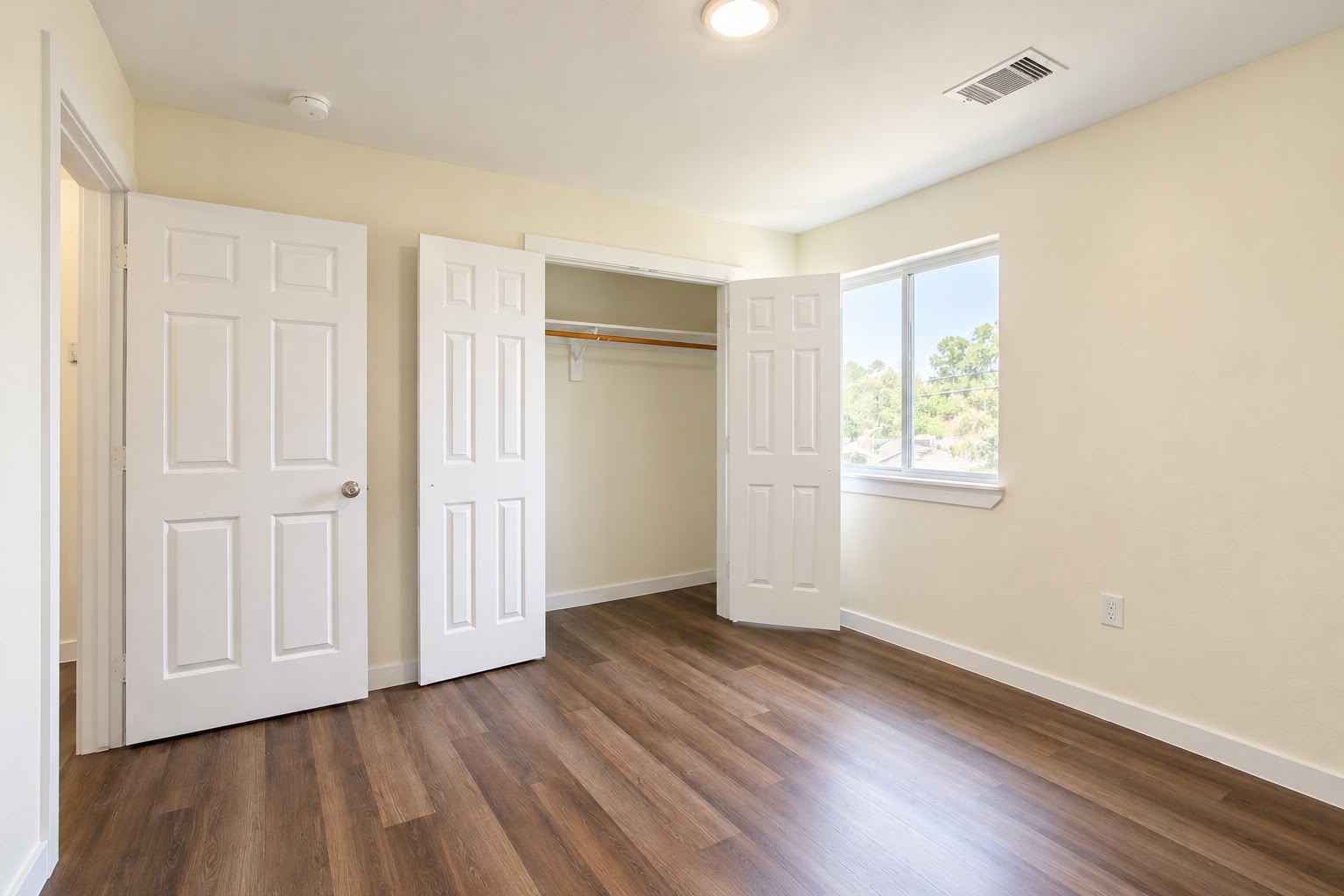 Bright bedroom with a spacious closet and natural light.